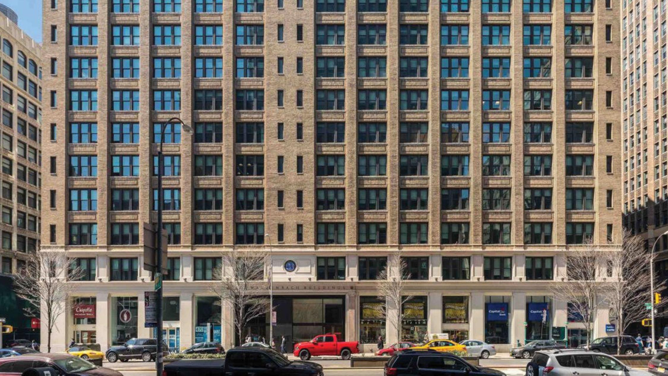 Exterior of 470 Park Avenue South's first 10 floors with cars on street in front