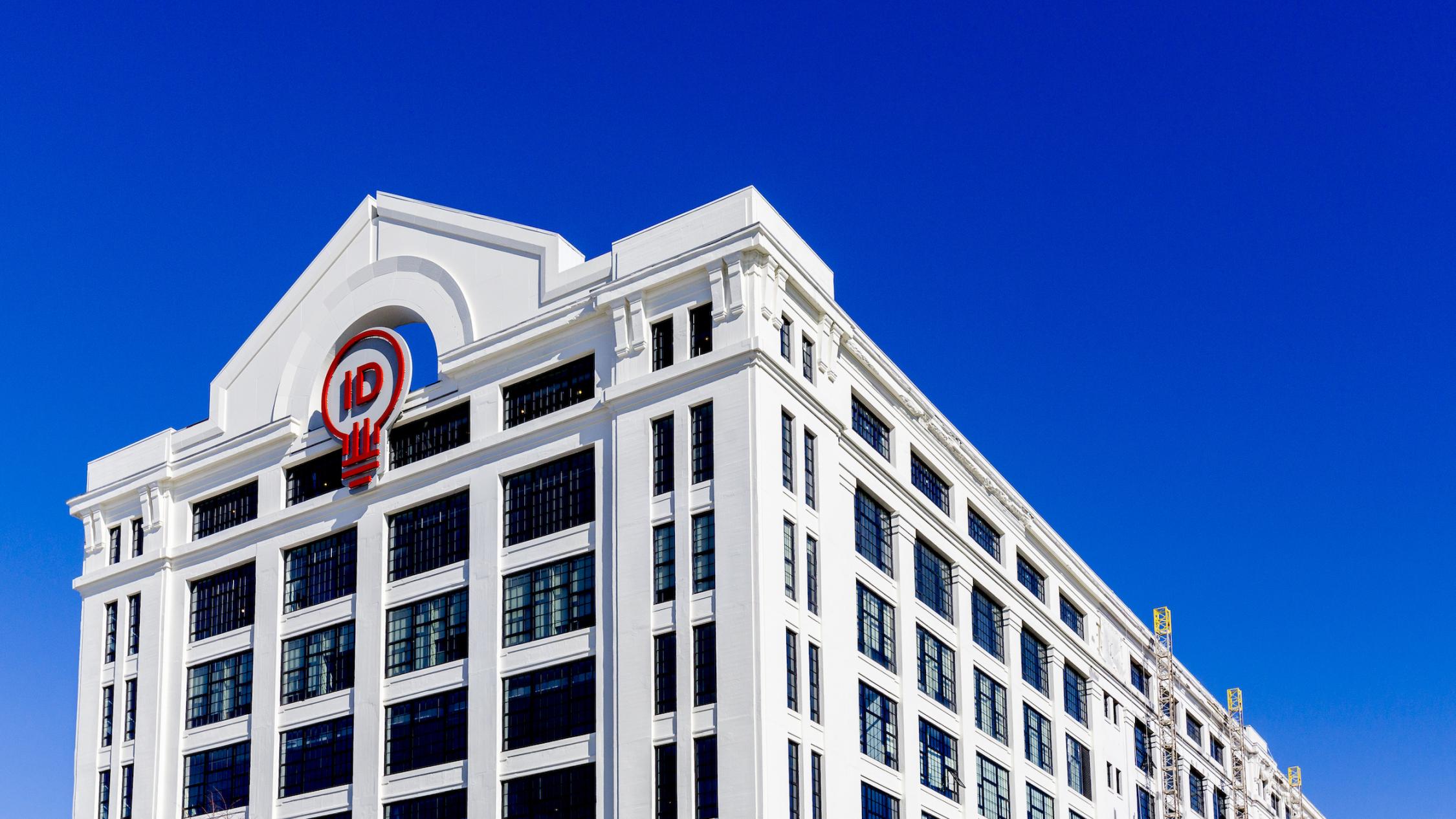 The exterior of The Innovation and Design Building under a clear blue sky