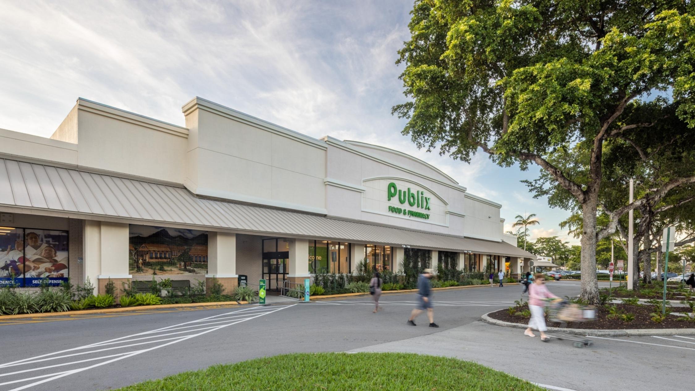 Publix grocery store exterior facade with pedestrians in driveway at Cypress Commons
