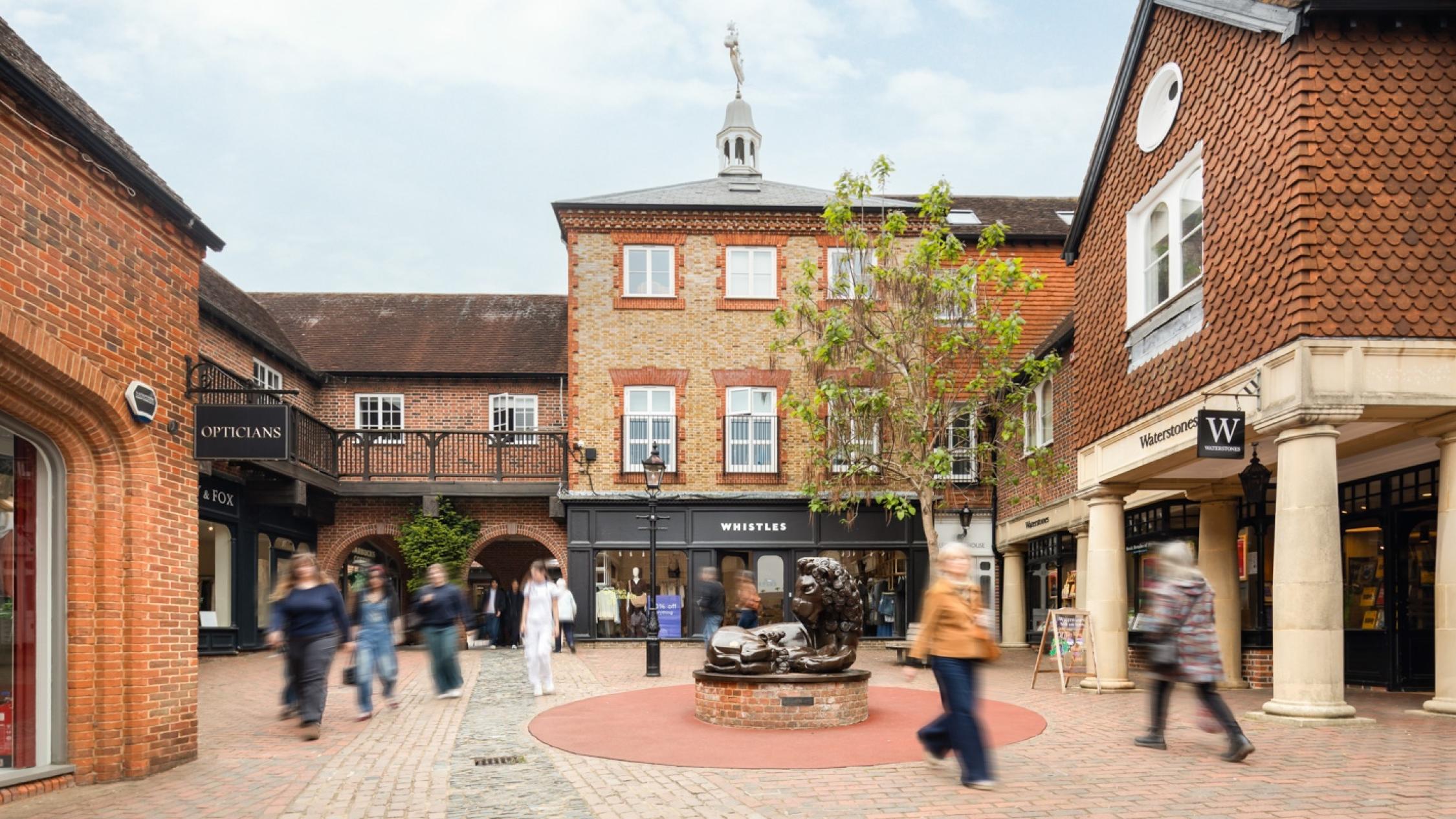 Visitors walking on a cobblestone street at the historic retail and residential property