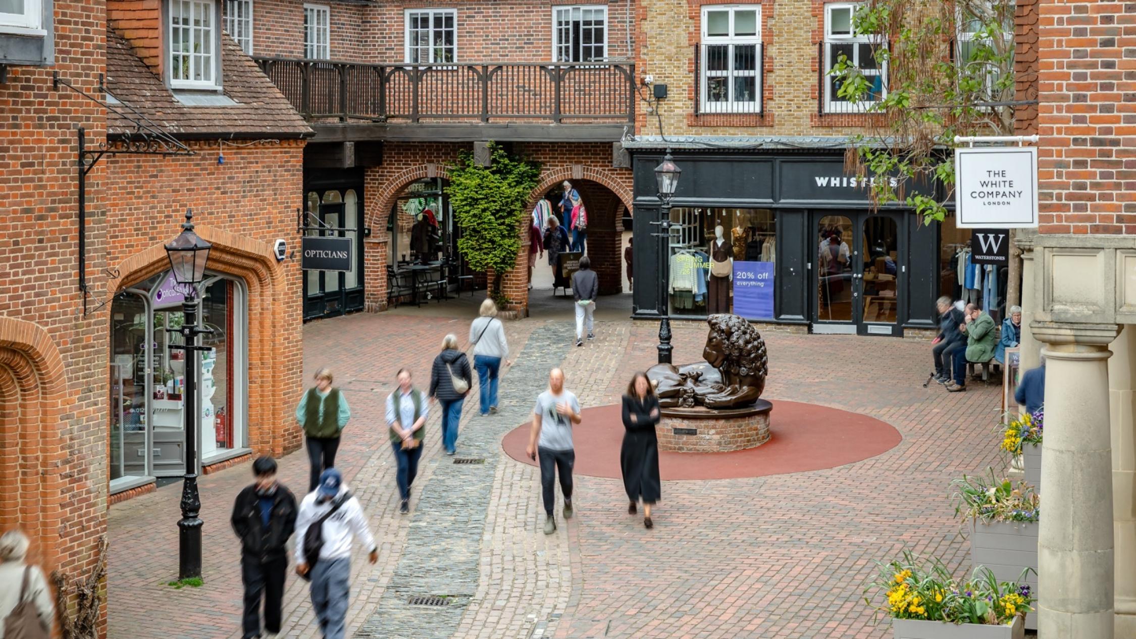 Visitors walking on a cobblestone street at the historic retail and residential property