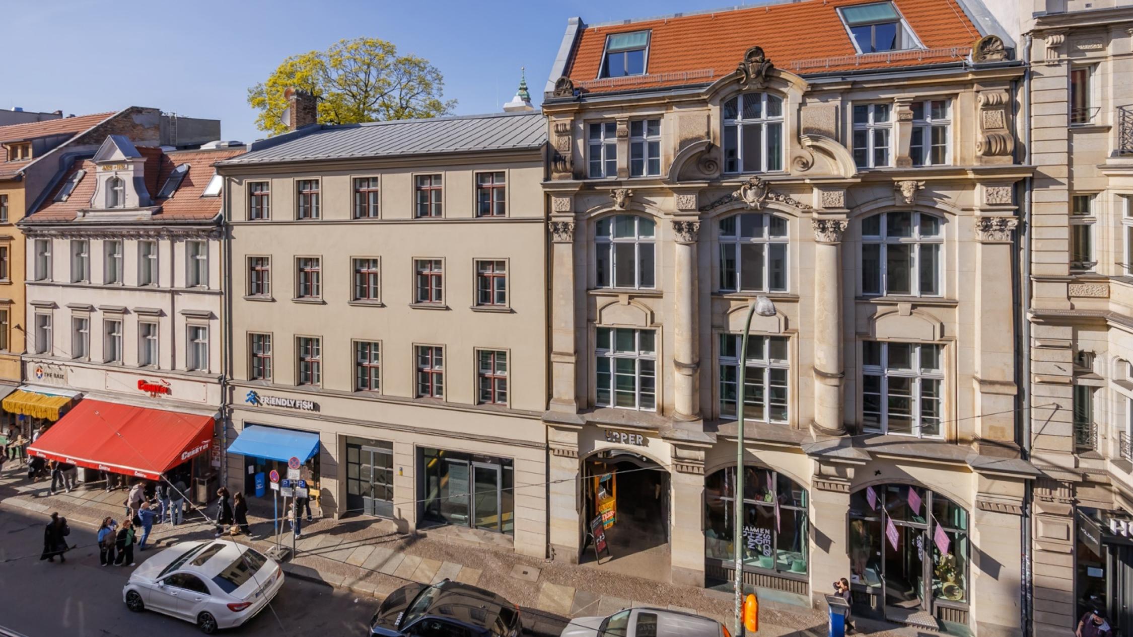 Building facades along Oranienburger Straße with people walking on sidewalk
