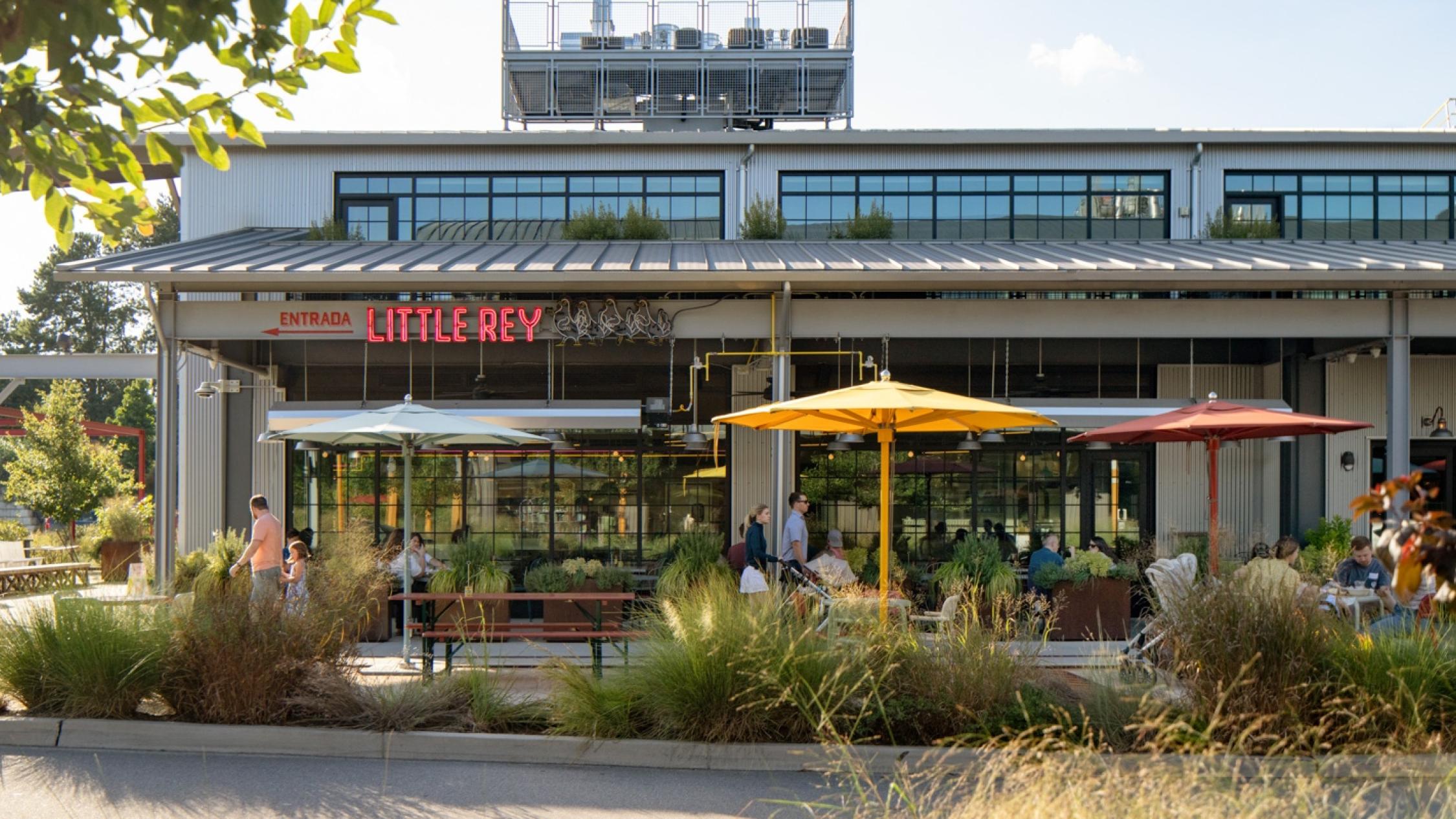 Restaurant facade with diners sitting at tables at Raleigh Iron Works