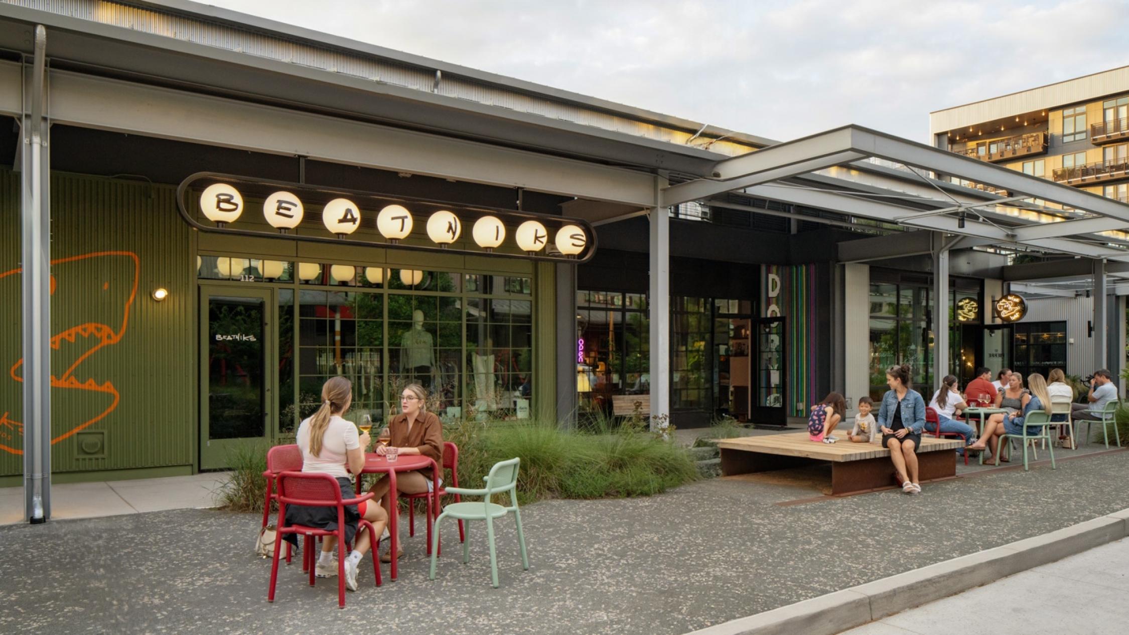 Restaurant facade with diners sitting at tables at Raleigh Iron Works