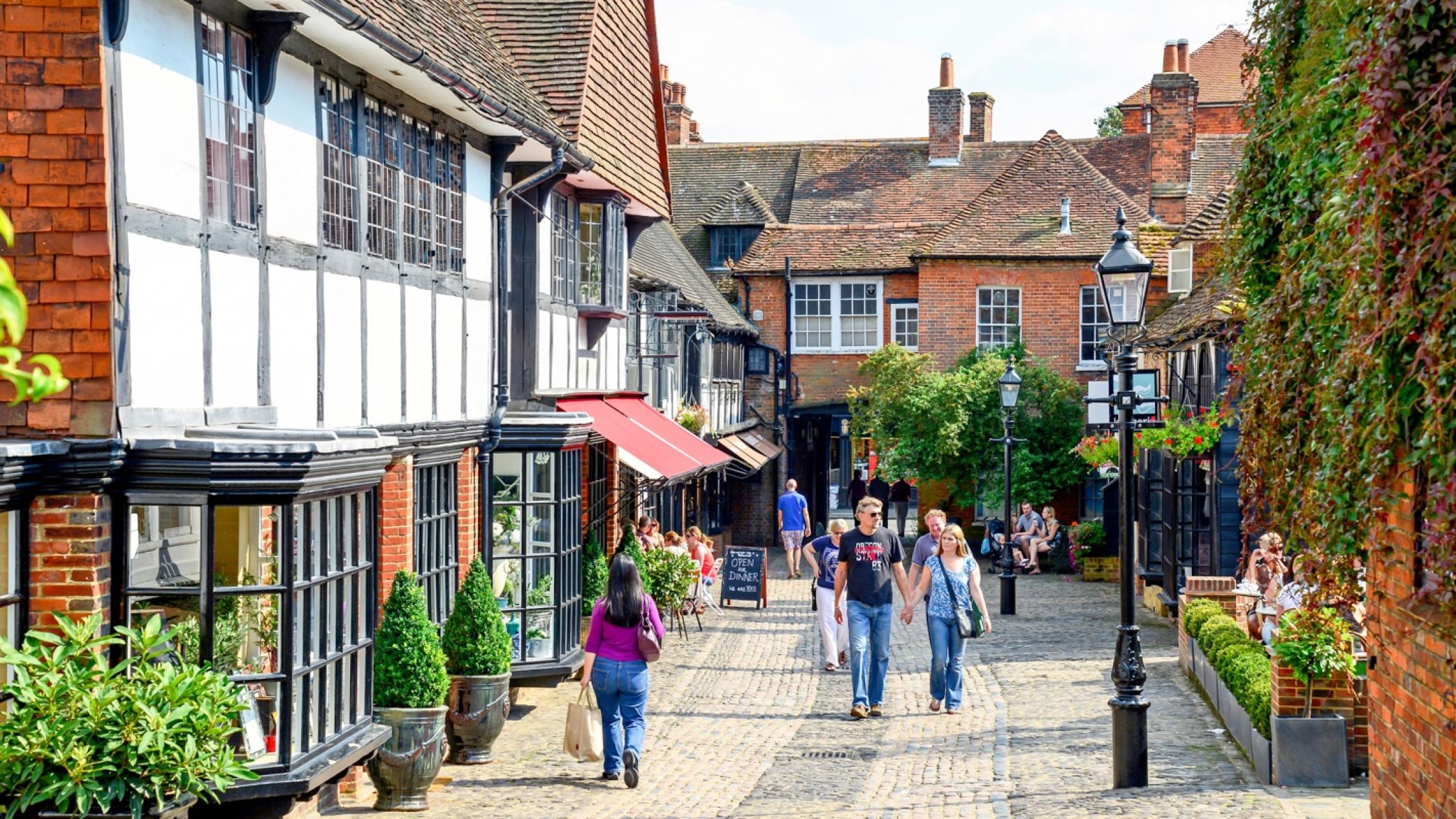 Visitors walking on a cobblestone street at the historic retail and residential property