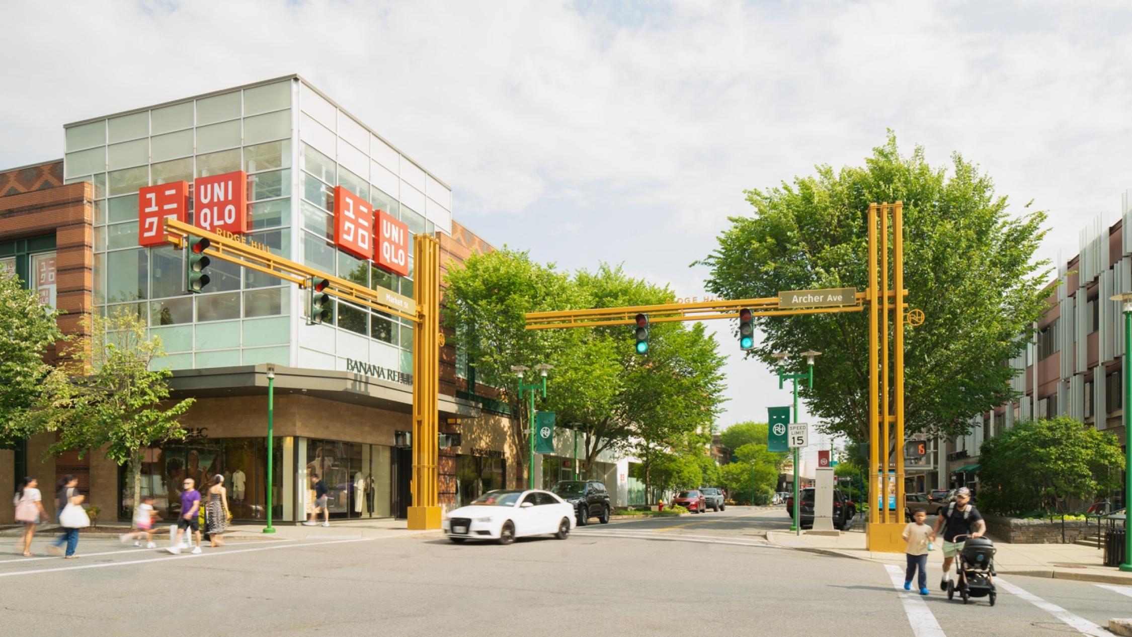View of visitors crossing intersecting streets surrounded by shops at Ridge Hill