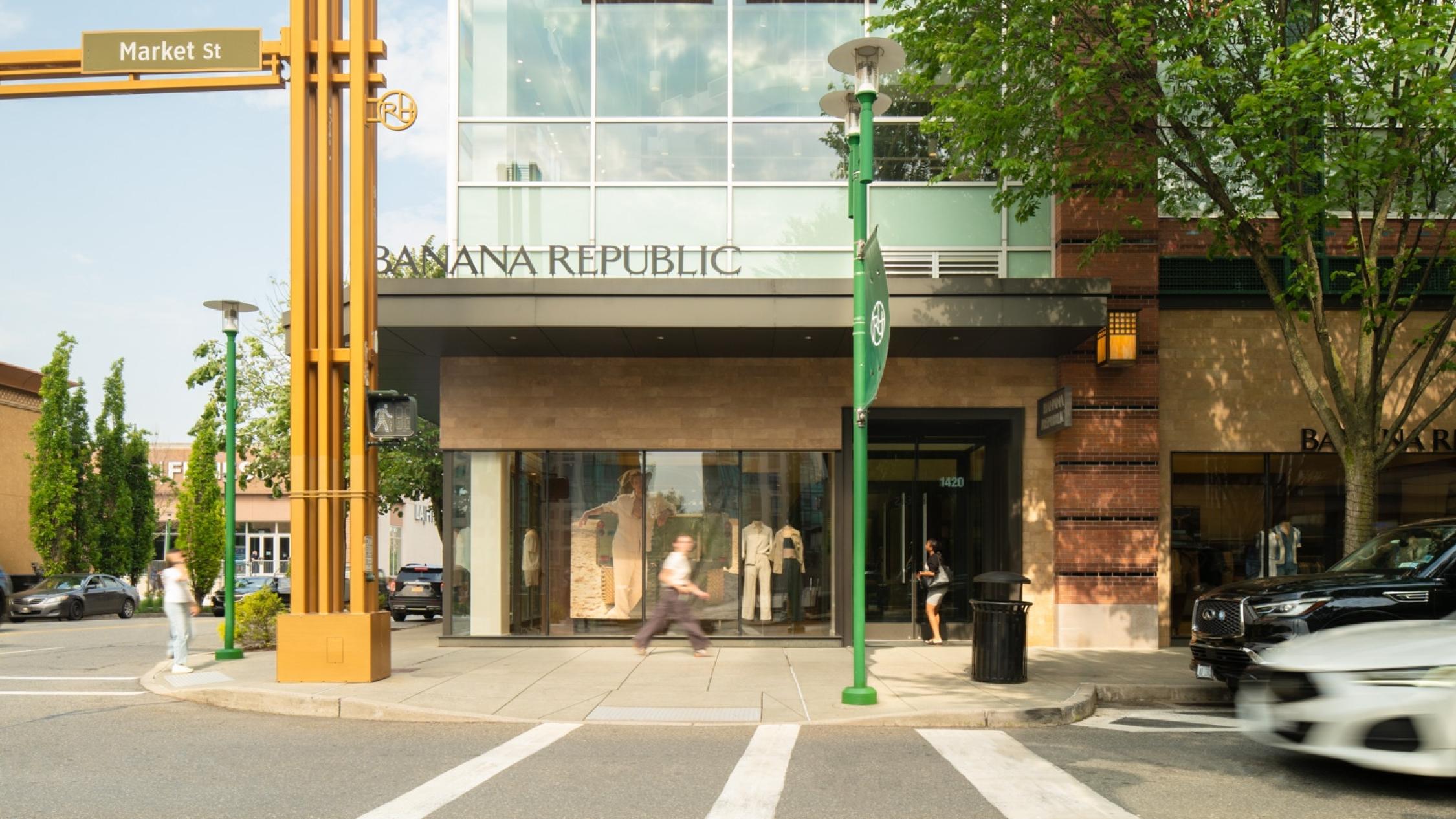 Visitors walking on the sidewalk in front of a shop at Ridge Hill