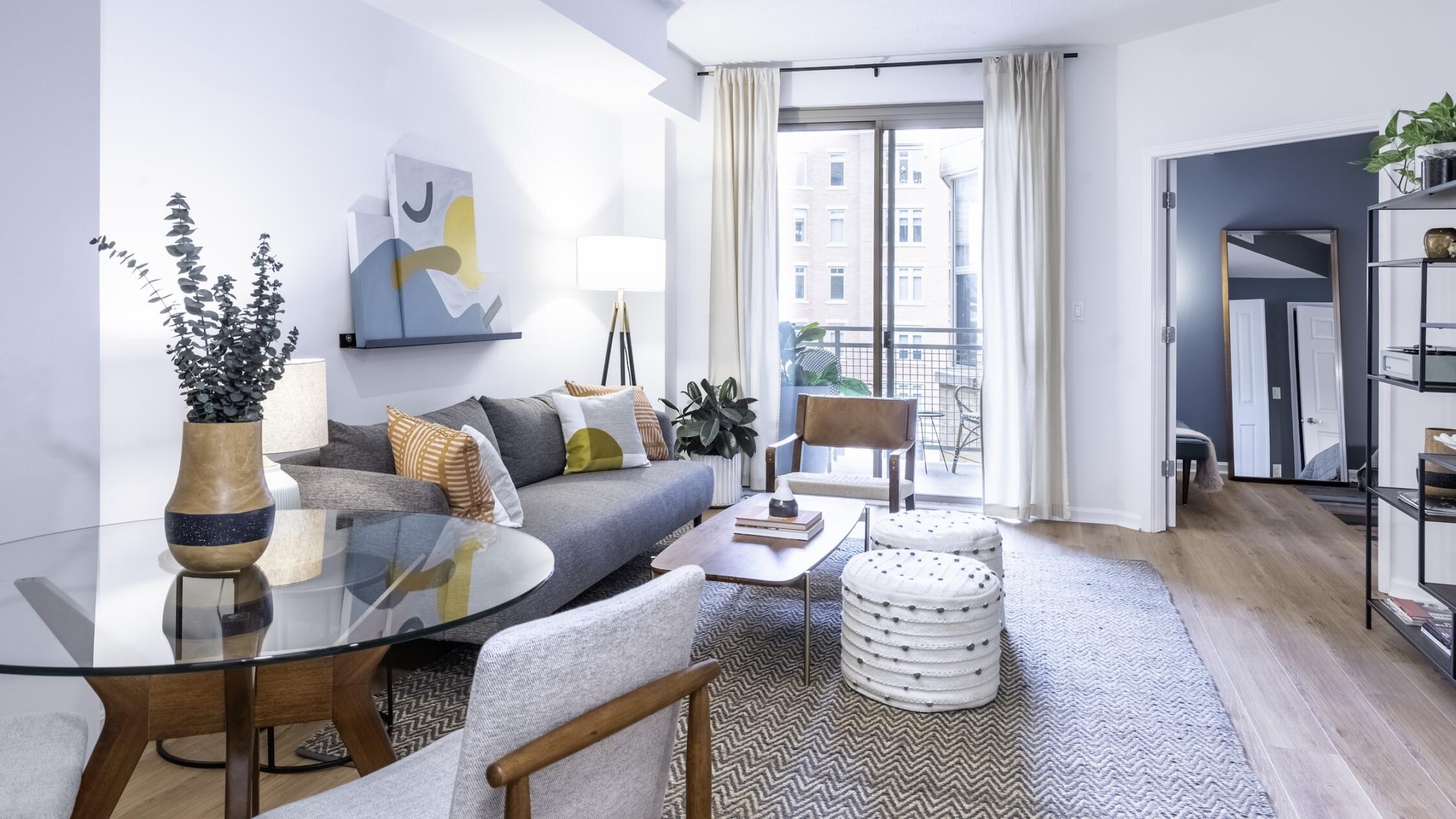 Living room of a model apartment at The Ellington with bright windows