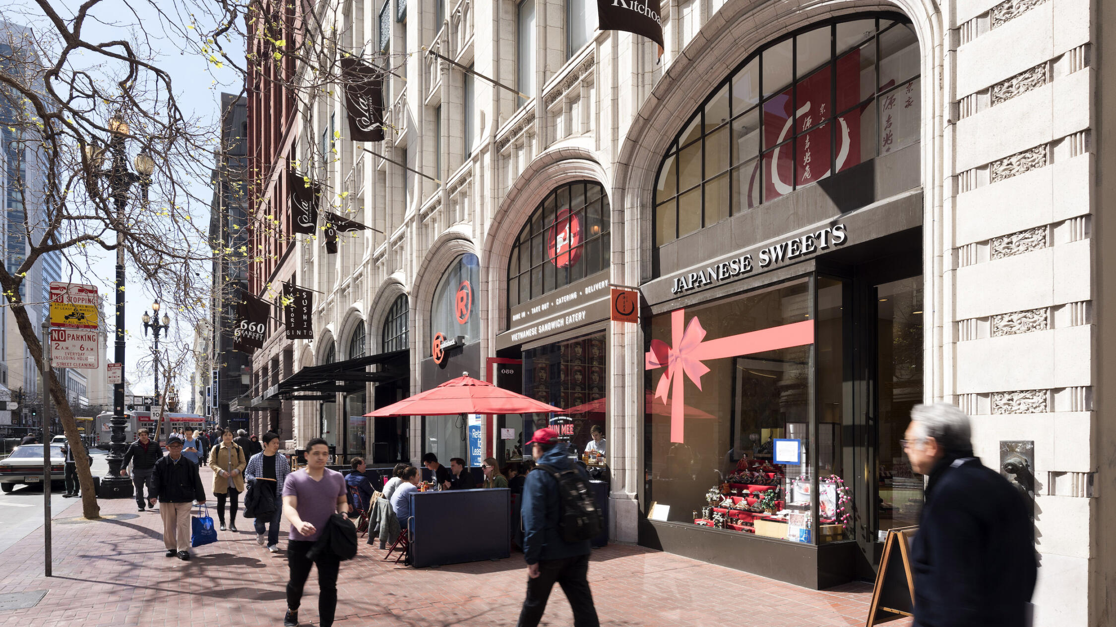 660 Market retail store facades with pedestrians on sidewalk