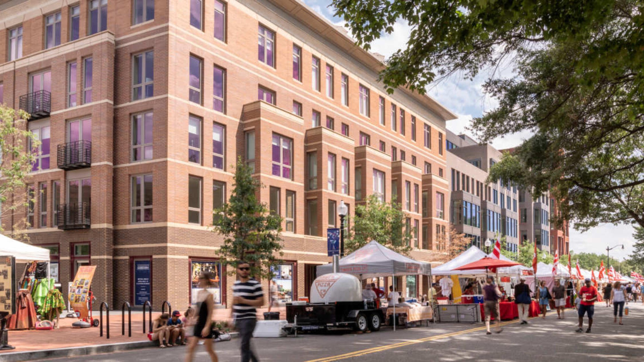 700 Penn building facade with street fair tents and pedestrians