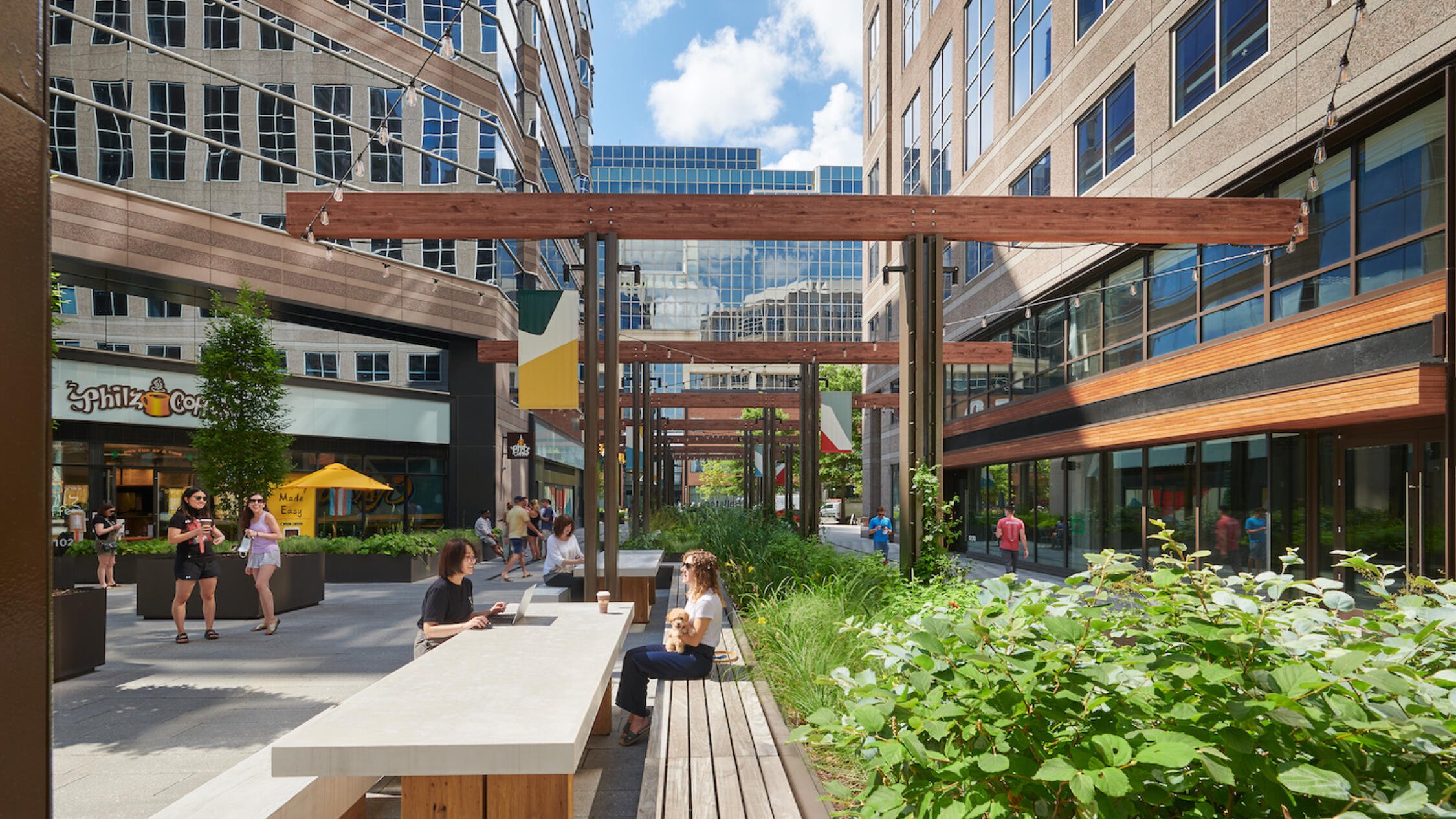 People sit outside at the paseo at Ballston Exchange