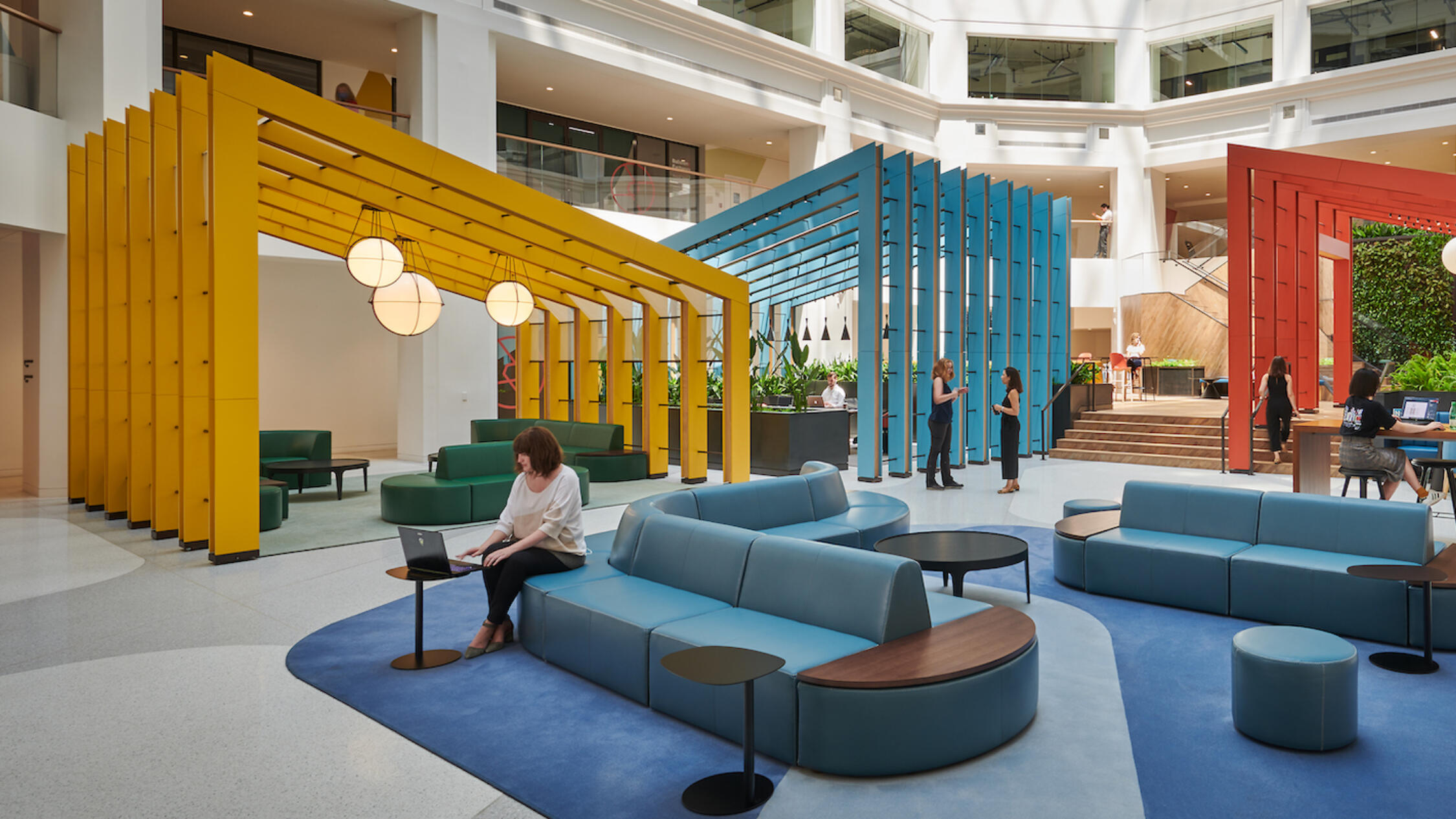 A woman works in the colorful lobby of Ballston Exchange