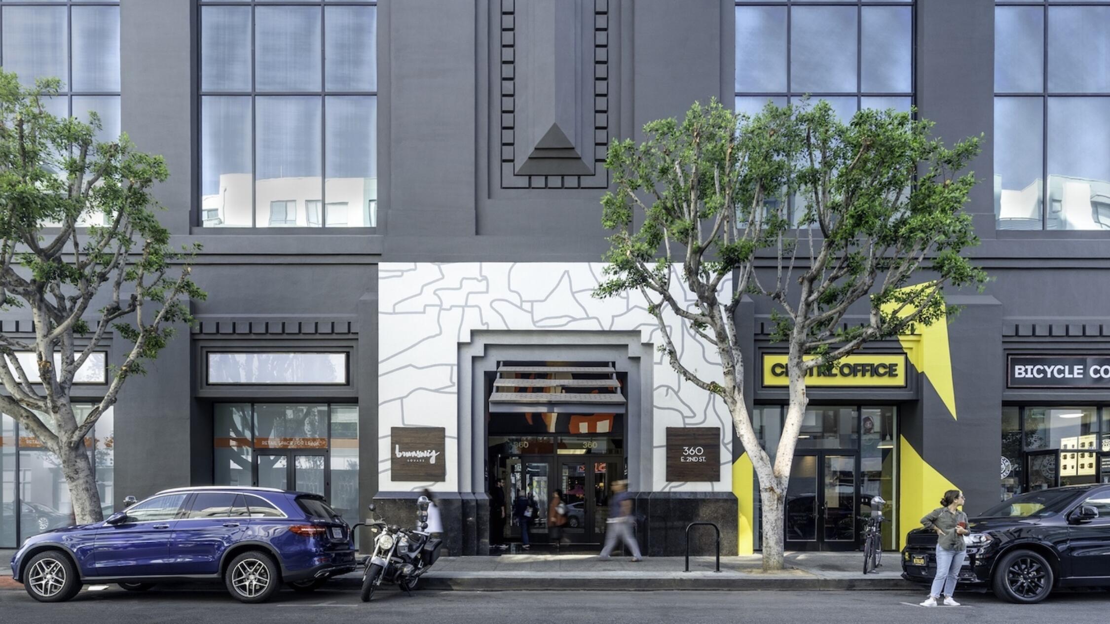 Brunswig Square exterior with office lobby entrance between retail stores