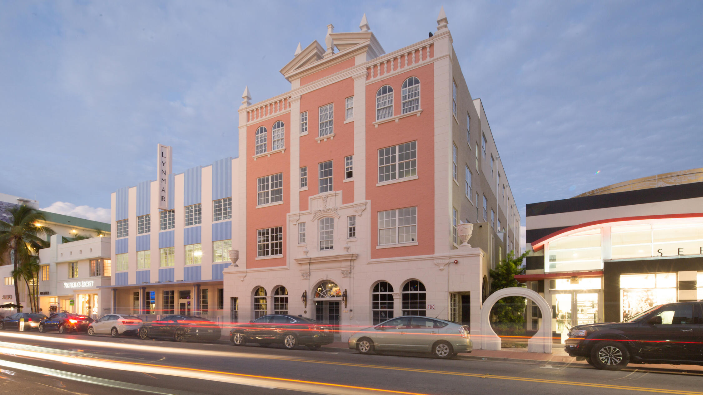 Collins Avenue Collection in the evening with cars moving past