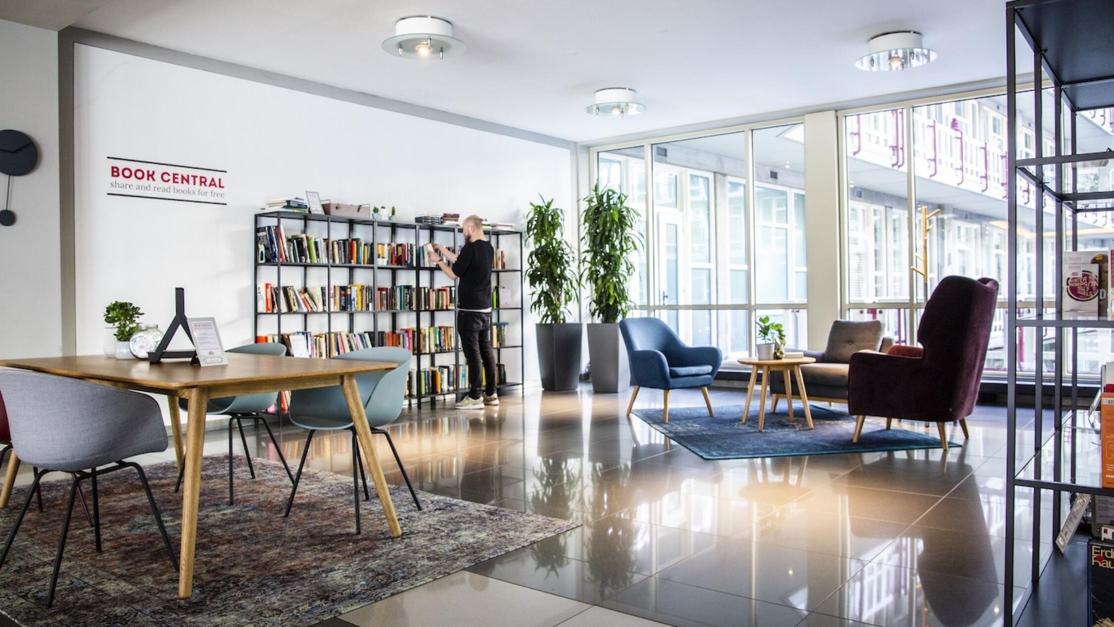 Groot Handelsgebouw interior common area with man browsing books on a shelf