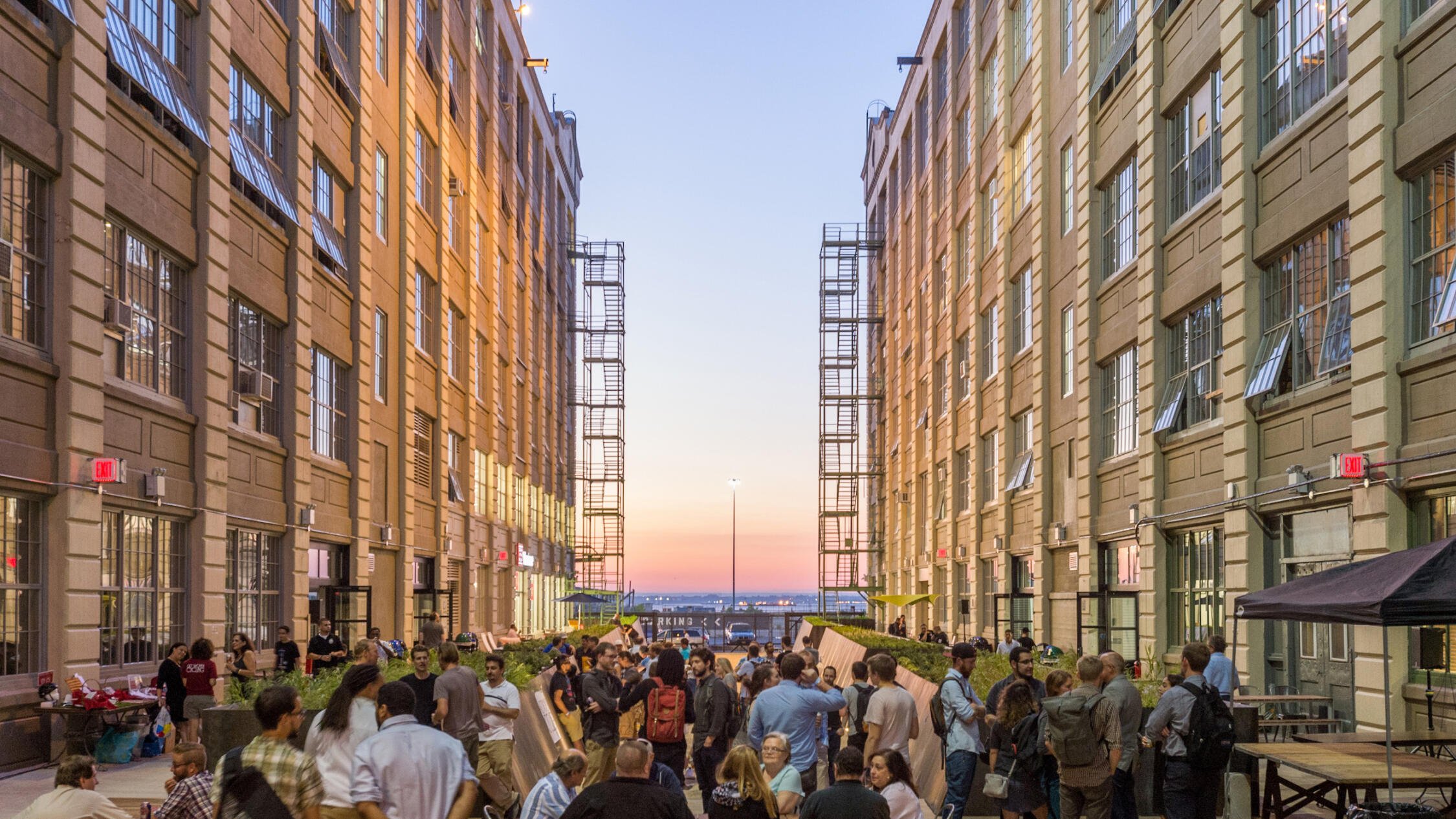 Industry City courtyard at dusk with attendees at an event