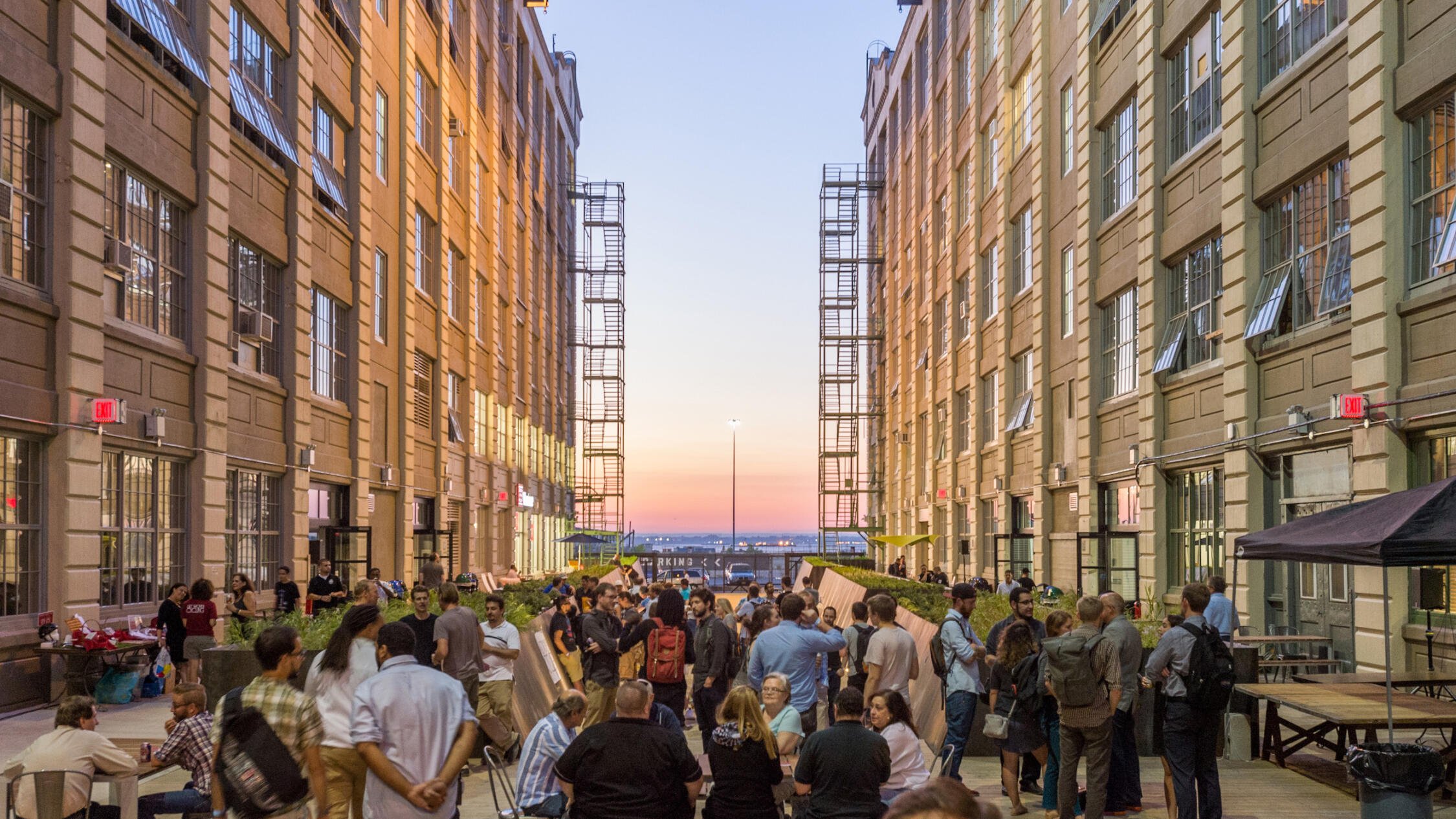 Industry City courtyard at dusk with attendees at an event