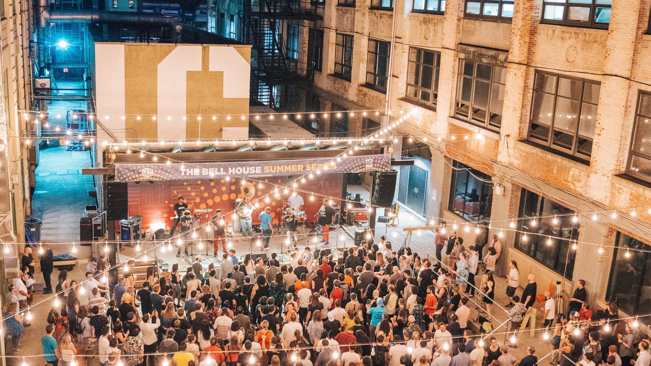 Industry City courtyard at night with attendees at an event