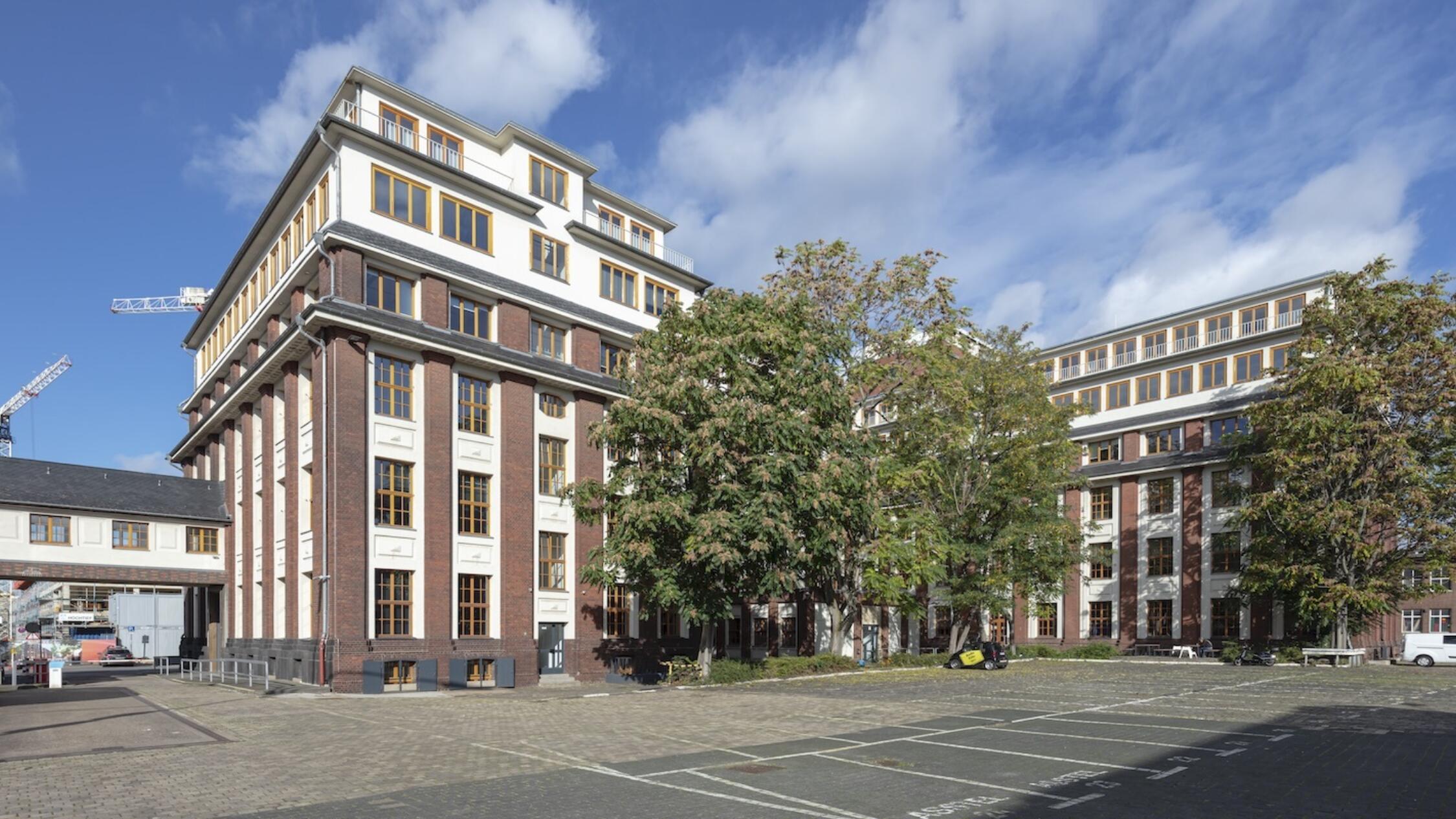 Schanzenstrasse facade with parking lot in foreground lot