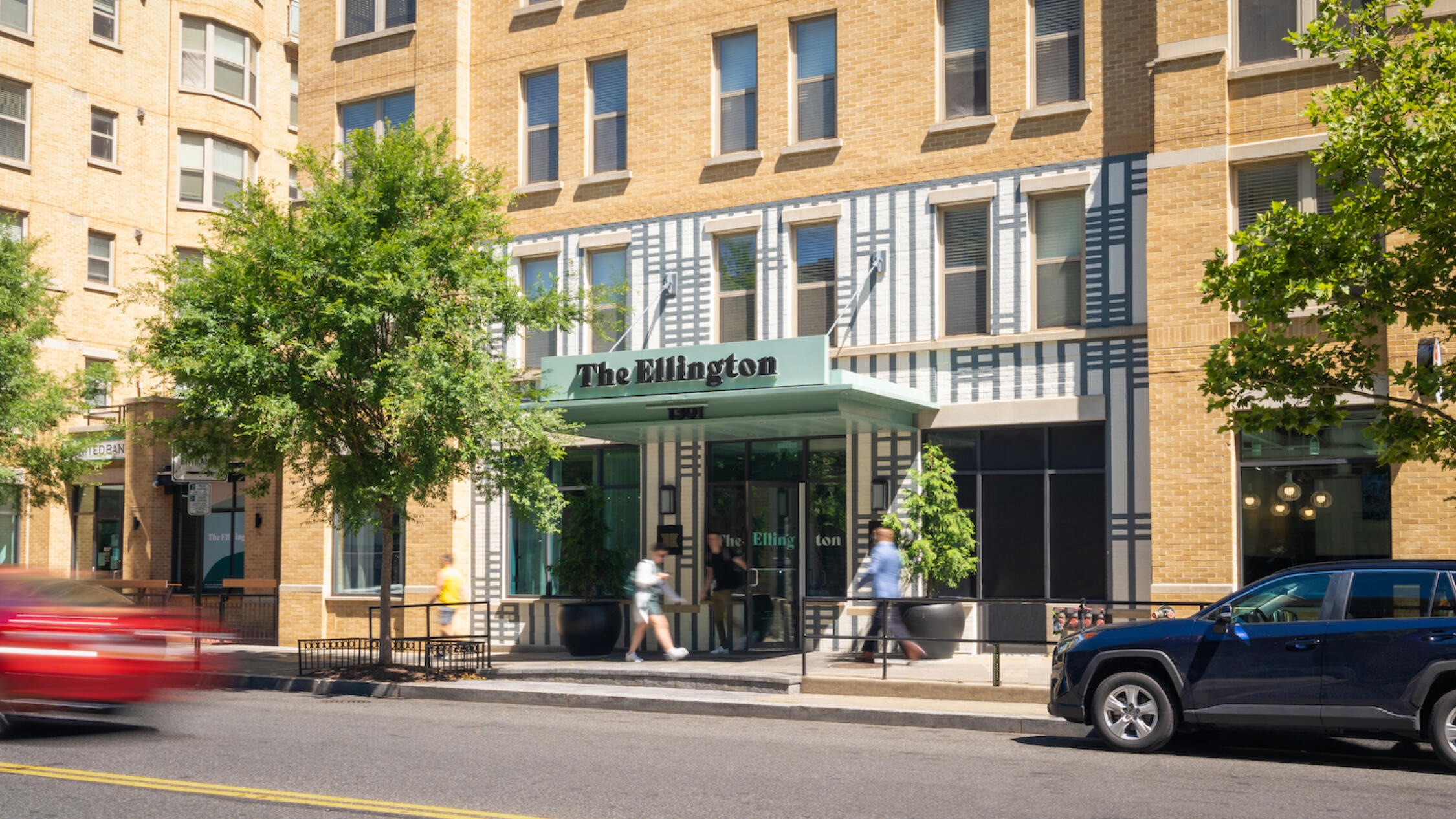 The exterior of The Ellington with people walking by