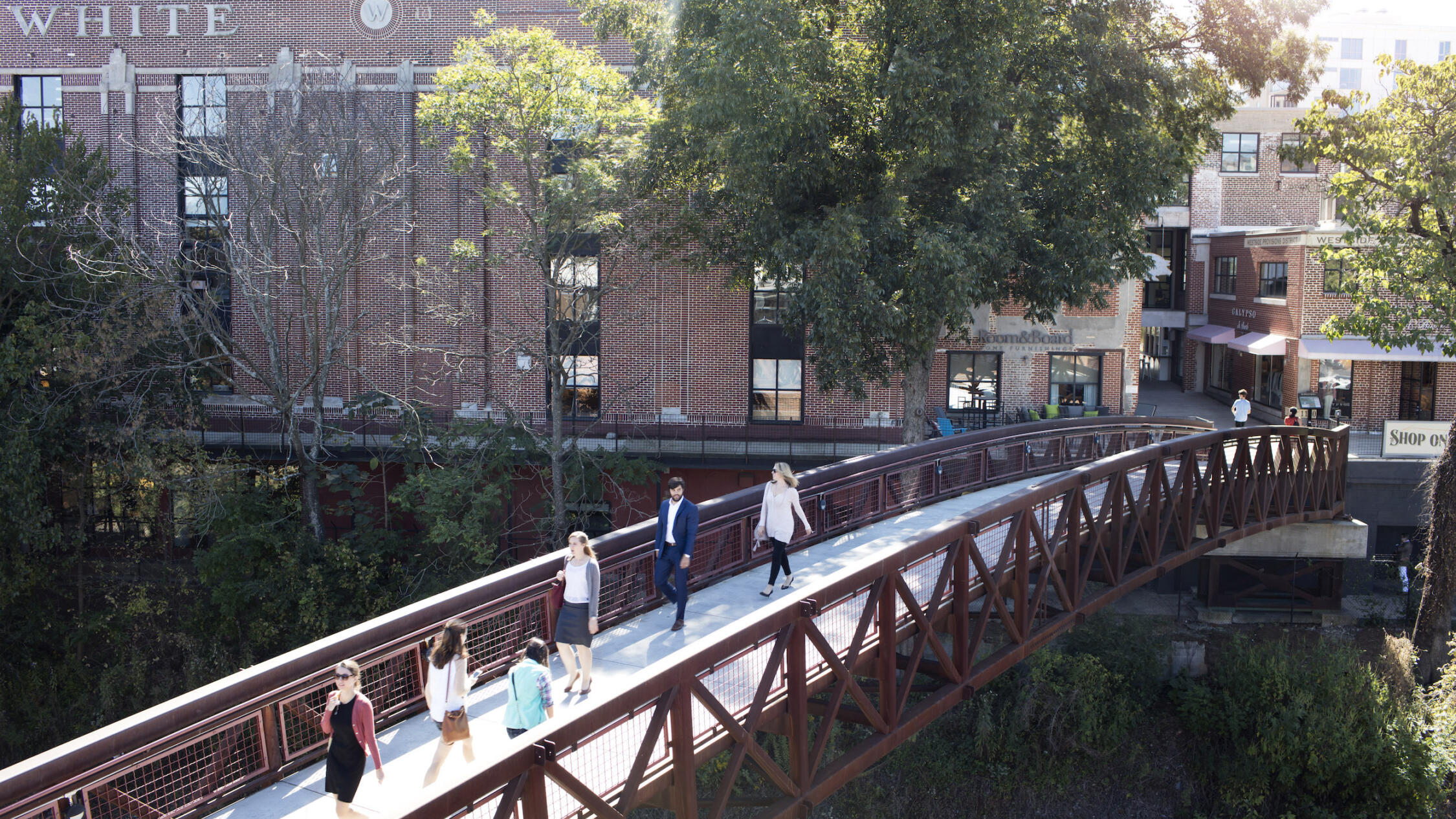 View of the bridge at Westside Provisions District in the daylight with people crossing over