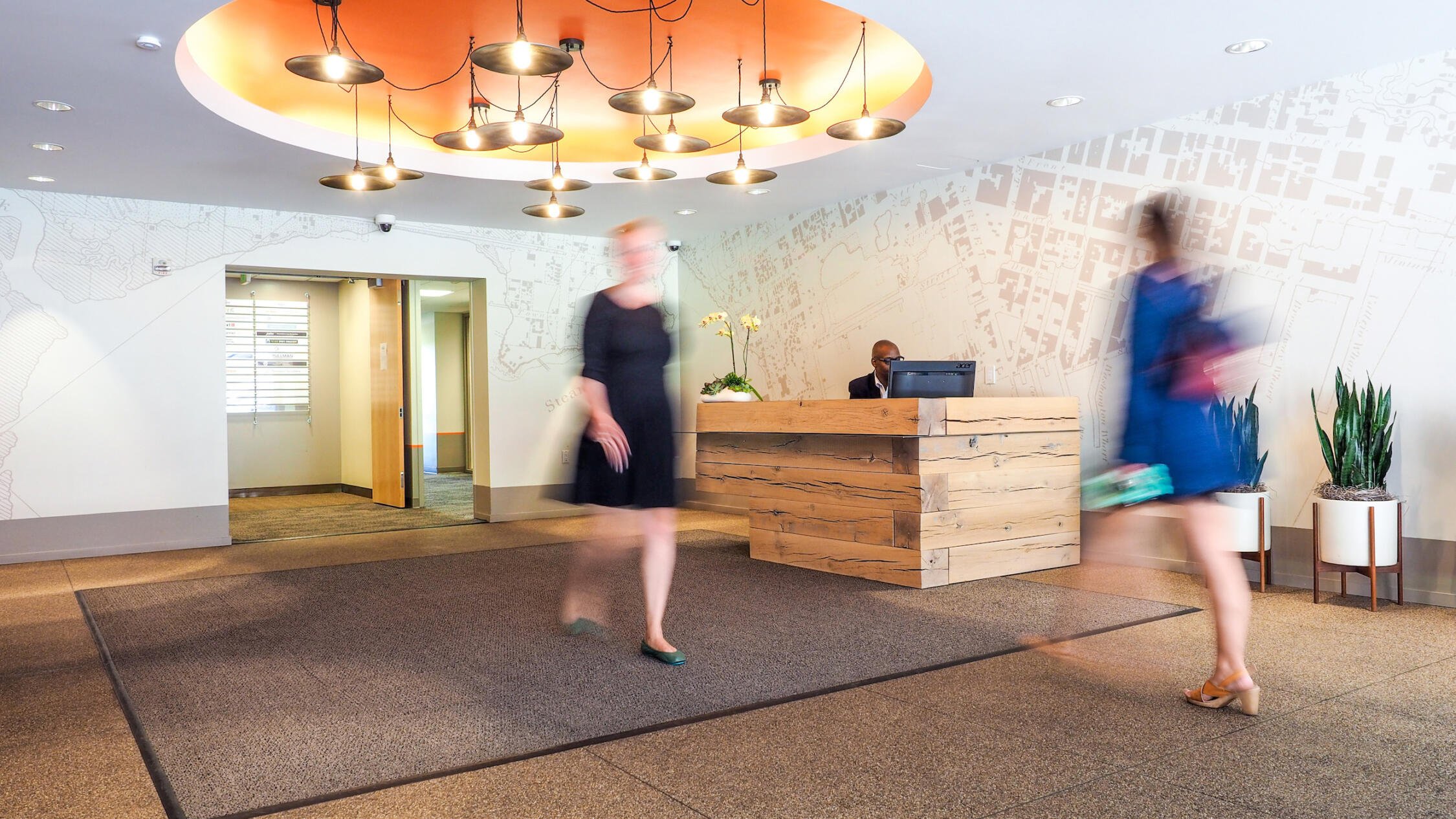 People pass through the lobby of Waterfront Plaza