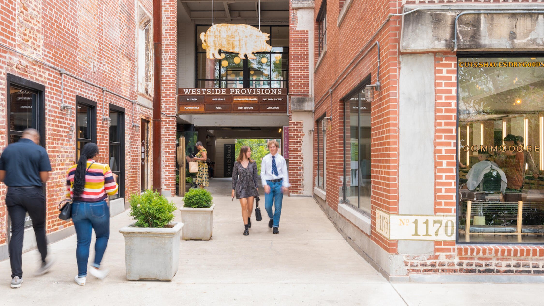 People walk through the main passageway at Westside Provisions District