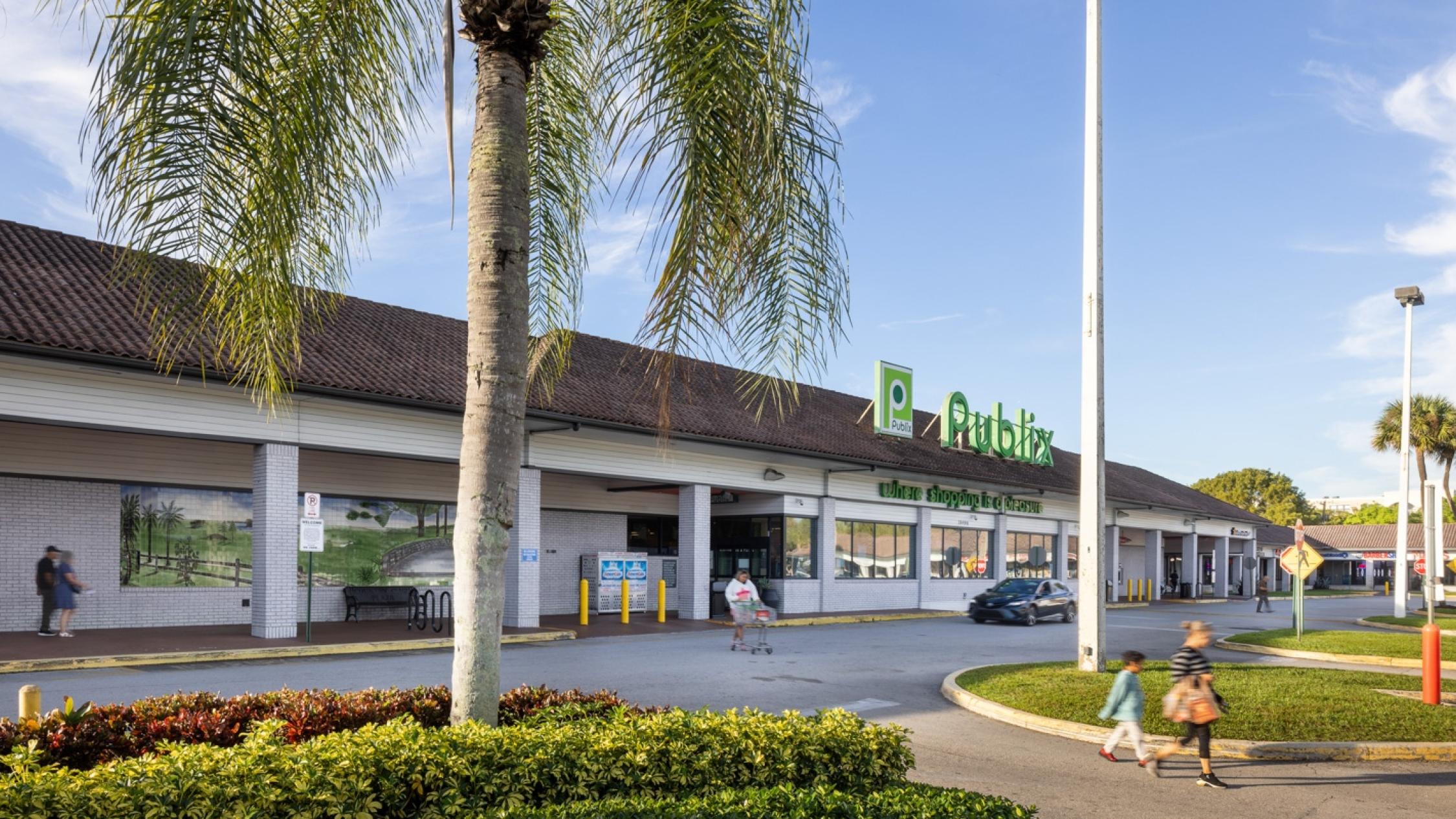 Country Club Plaza exterior of grocery store with pedestrians in driveway