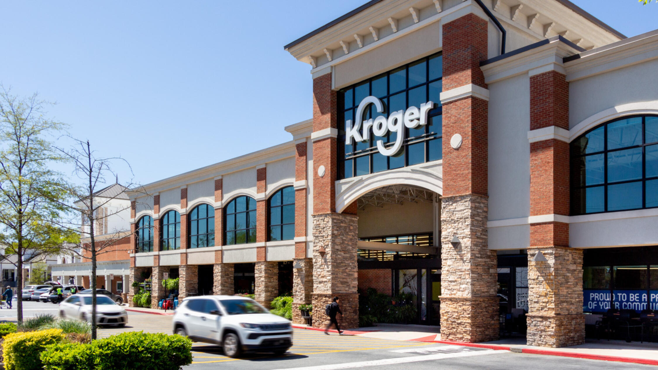Kroger façade at Fountain Oaks with cars and pedestrians on driveaway in front