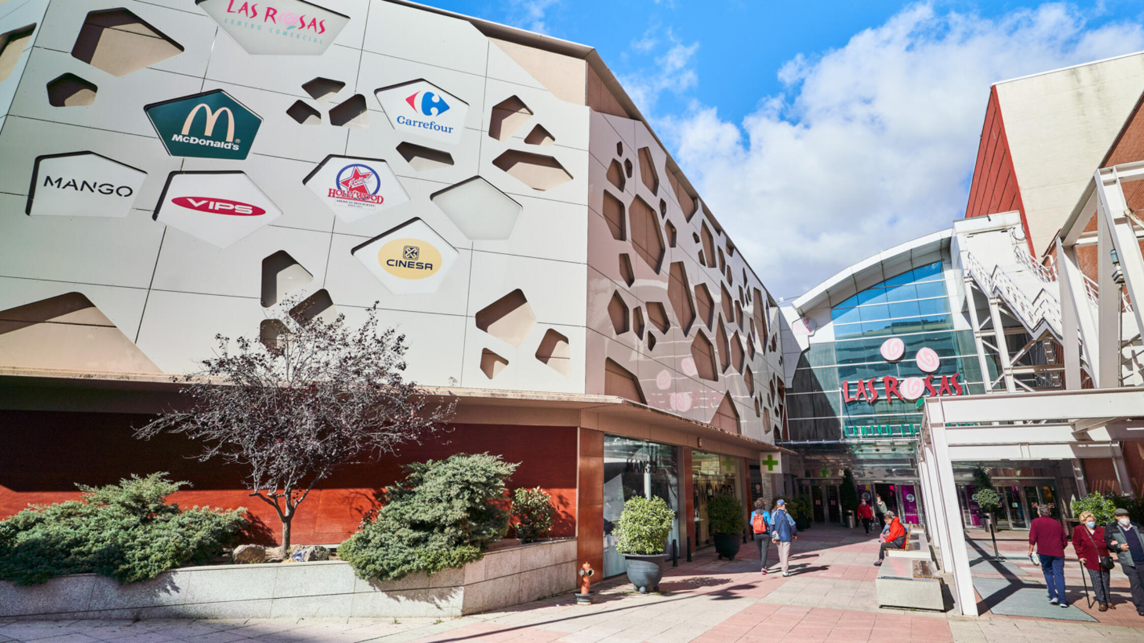 Las Rosas façade with visitors near entrance