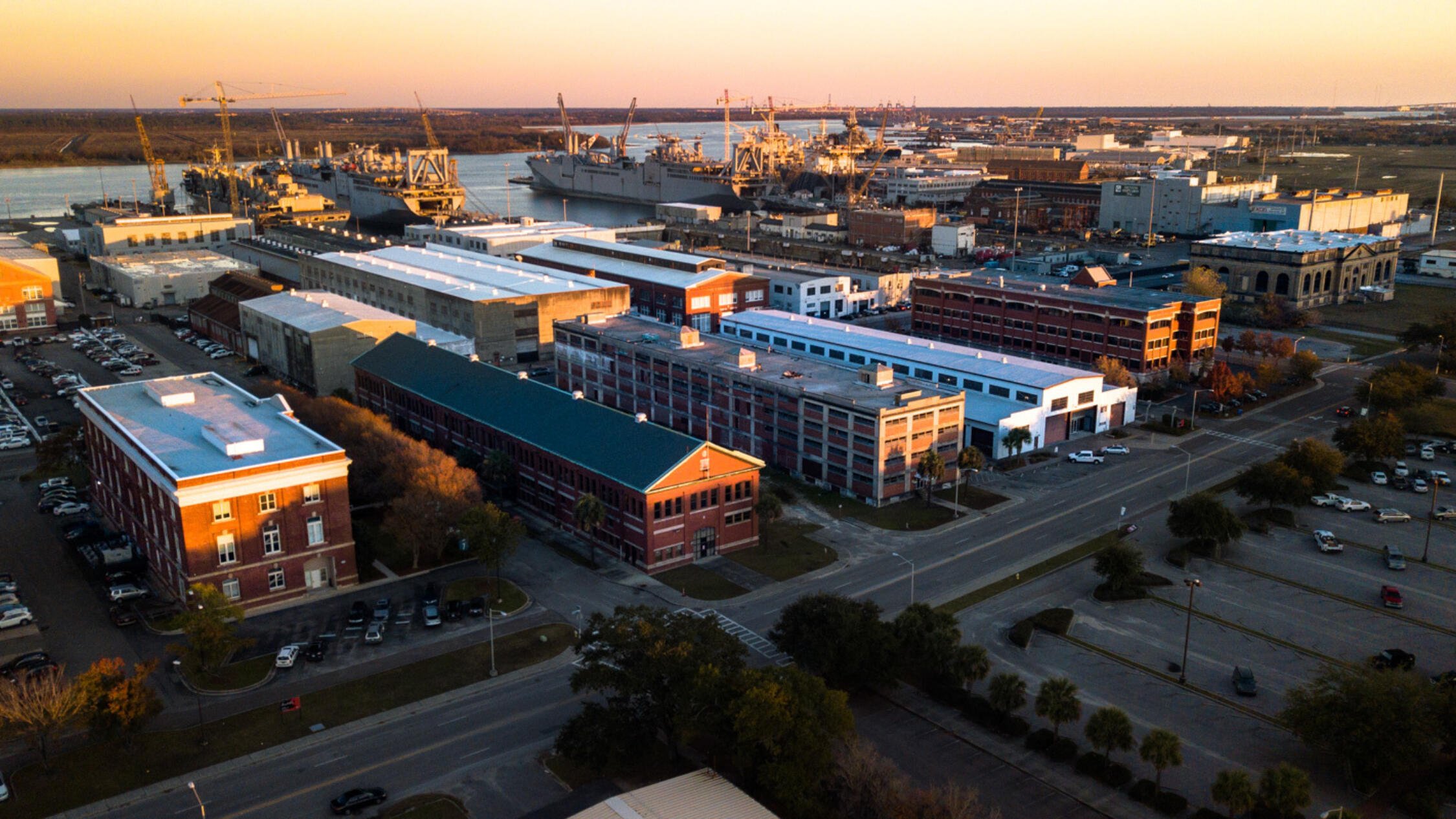 Aerial view of Navy Yard Charleston during dusk with waterway in background