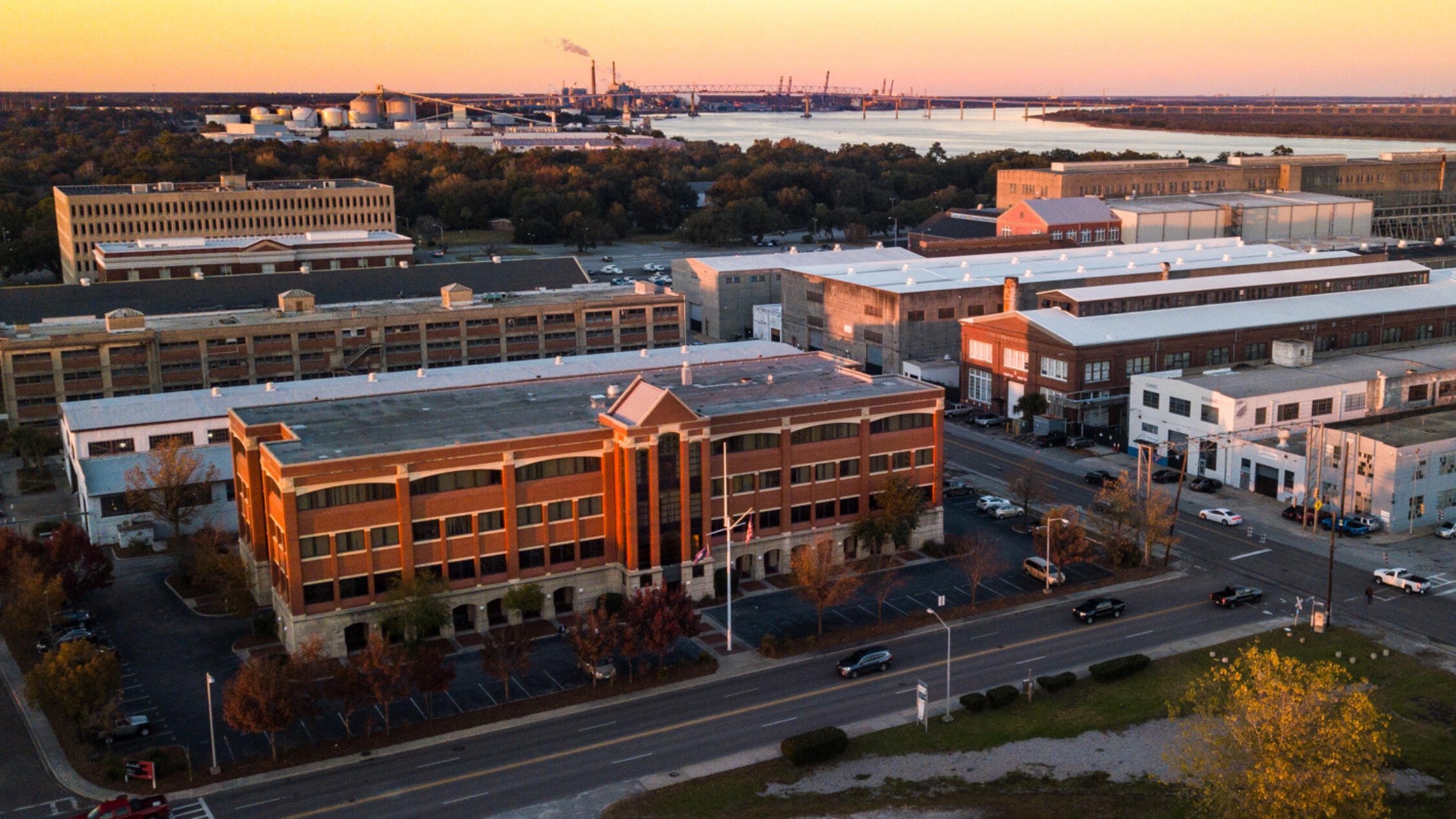 Aerial view of Navy Yard Charleston during dusk with waterway in background