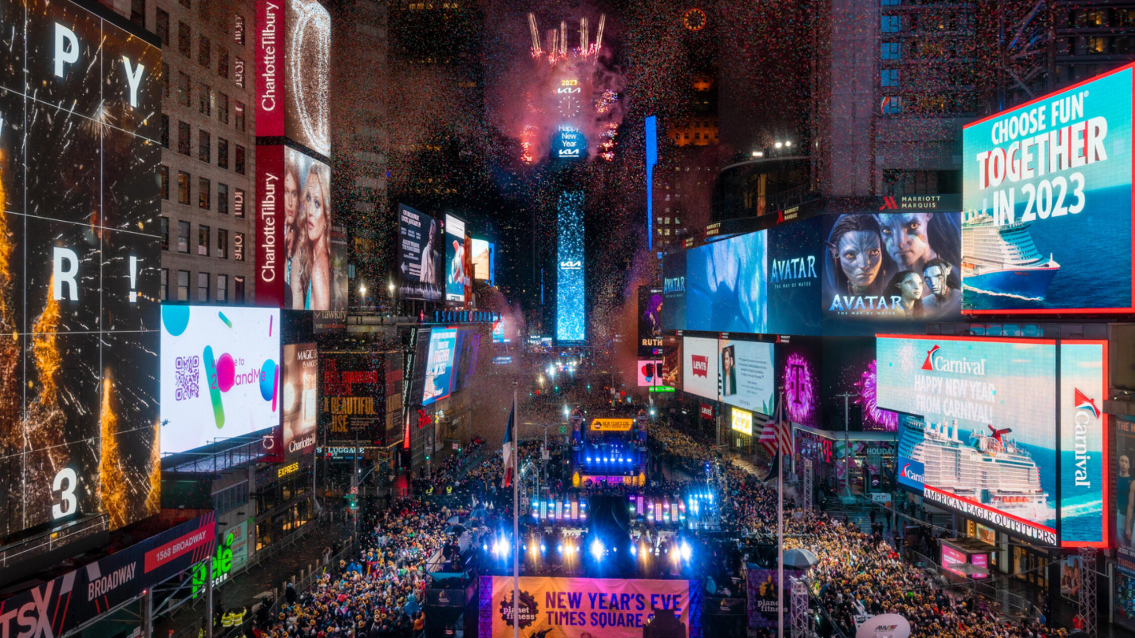 Massive crowd in Times Square for New Year's Eve celebration with ball drop and fireworks on the One Times Square building