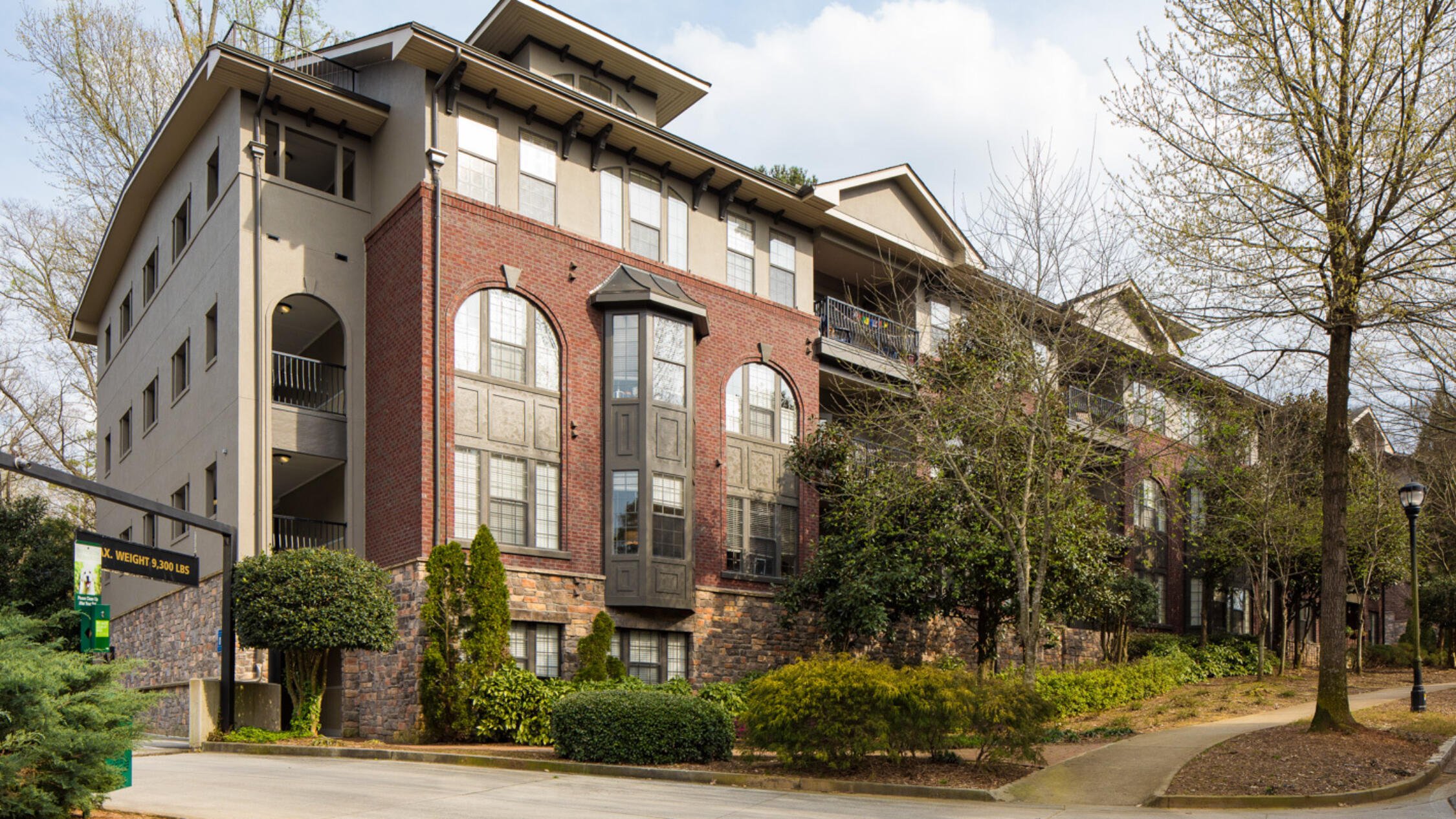 Rock Springs Village facade with landscaped areas and parking entrance beside building