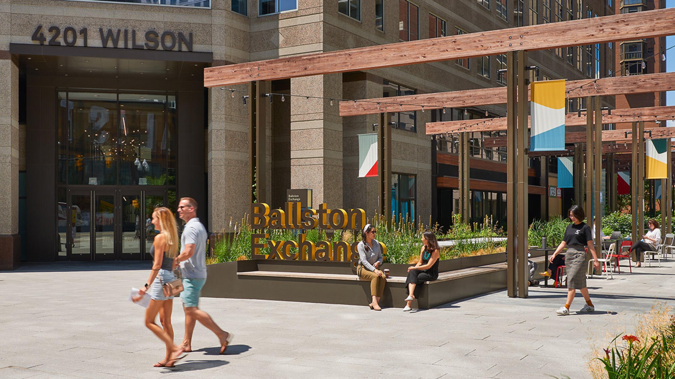 People outside in the sunshine at Ballston Exchange