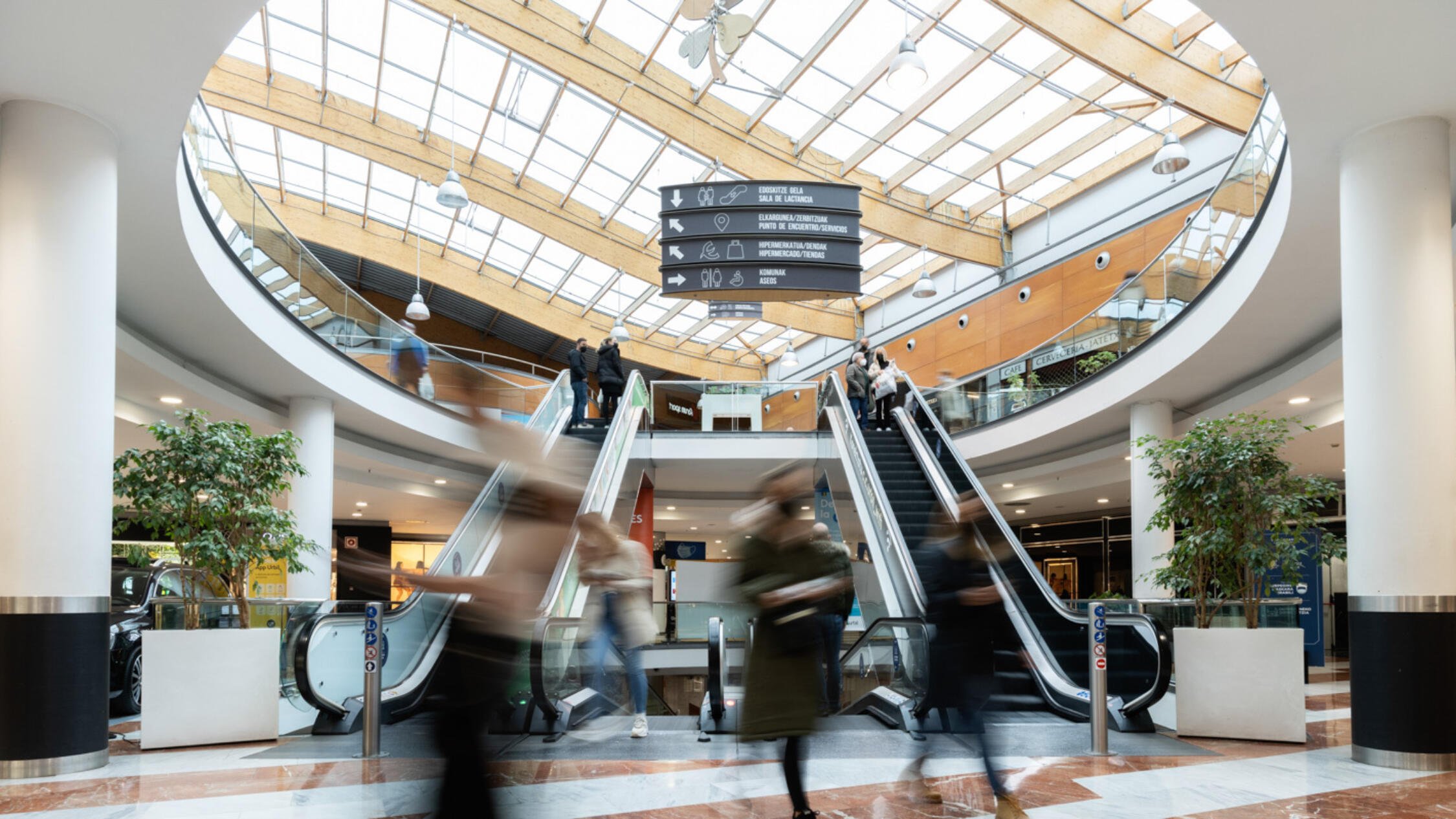 Urbil interior atrium with visitors coming off the escalator