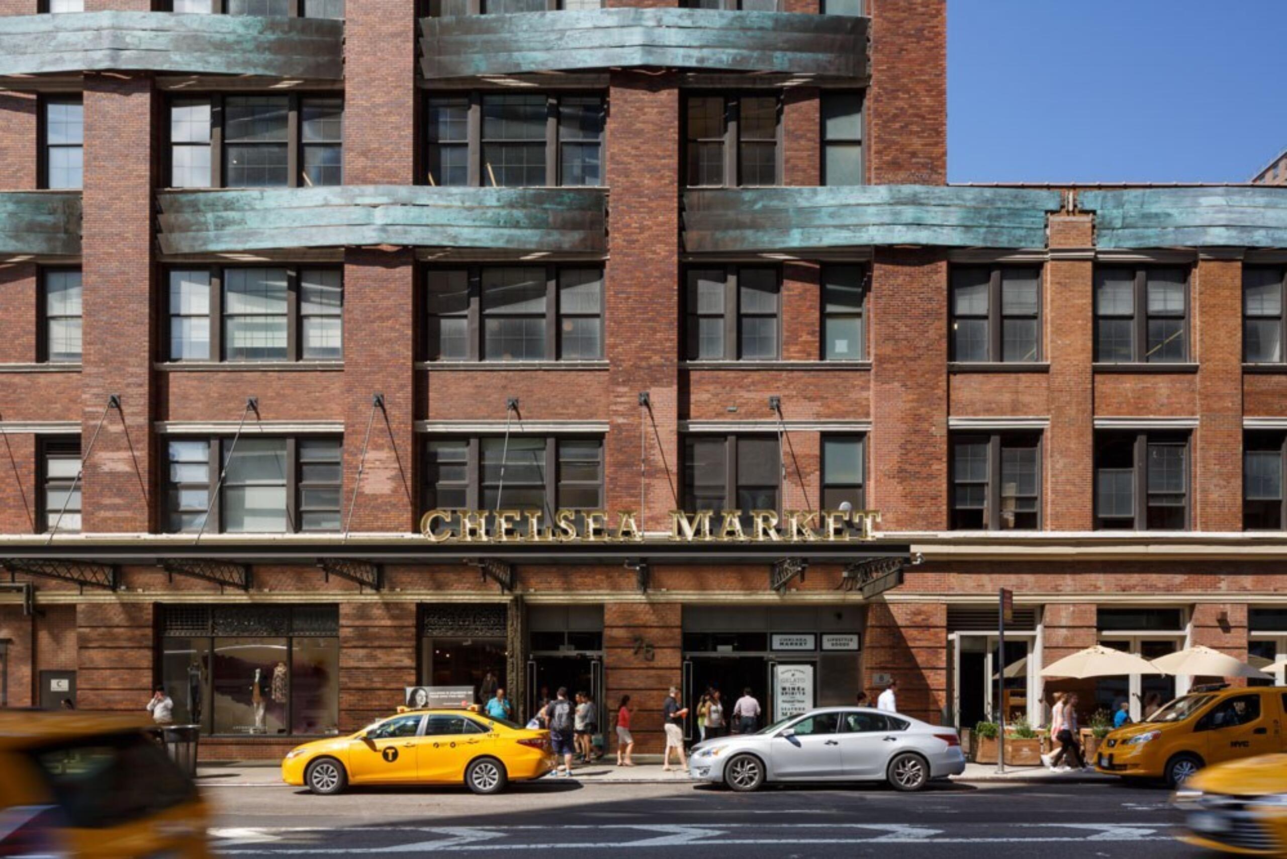 Facade of Chelsea Market with New York City yellow cabs out front