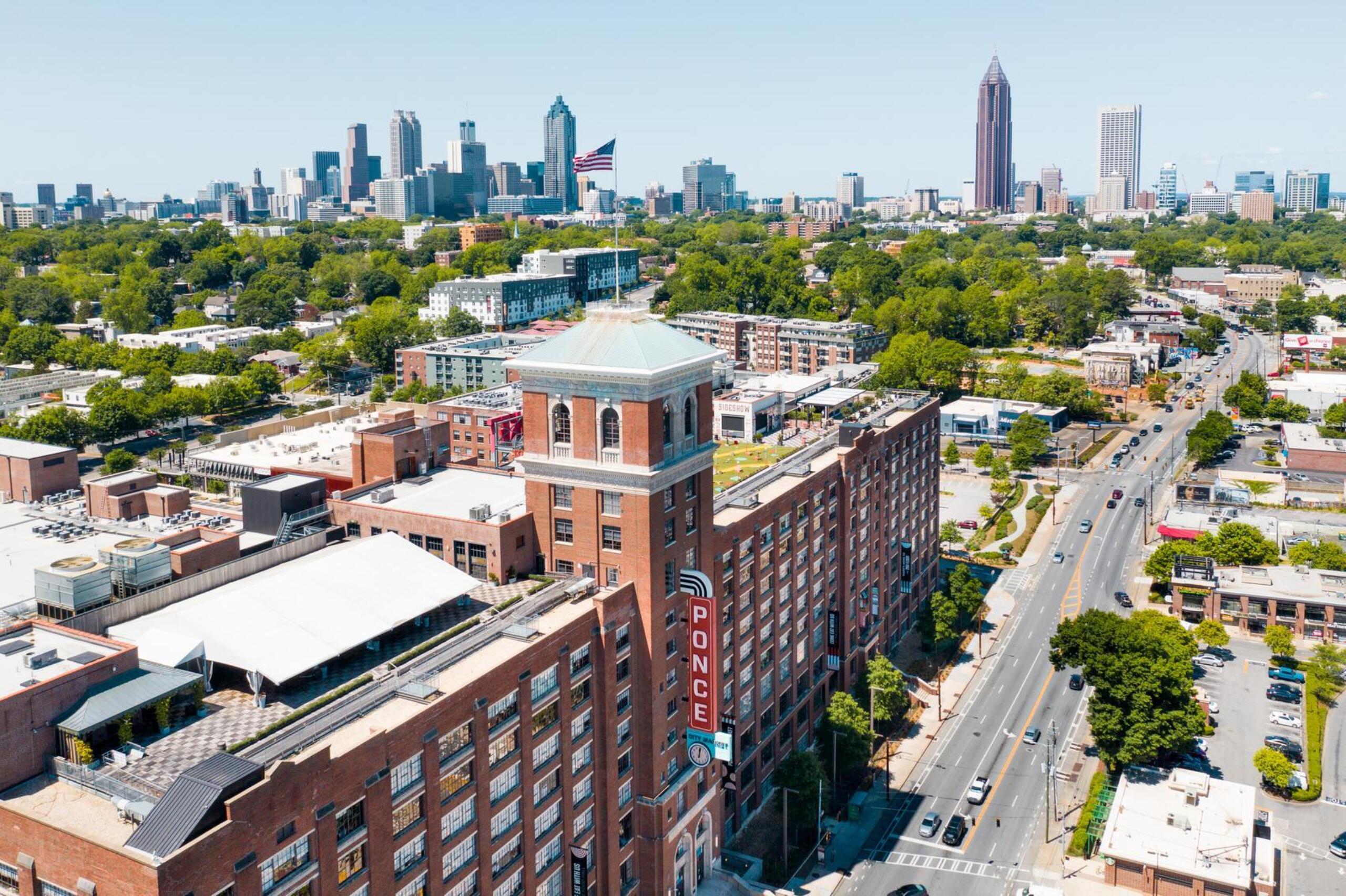 Aerial view of Ponce City Market and Ponce de Leon Avenue with Atlanta skyline in background