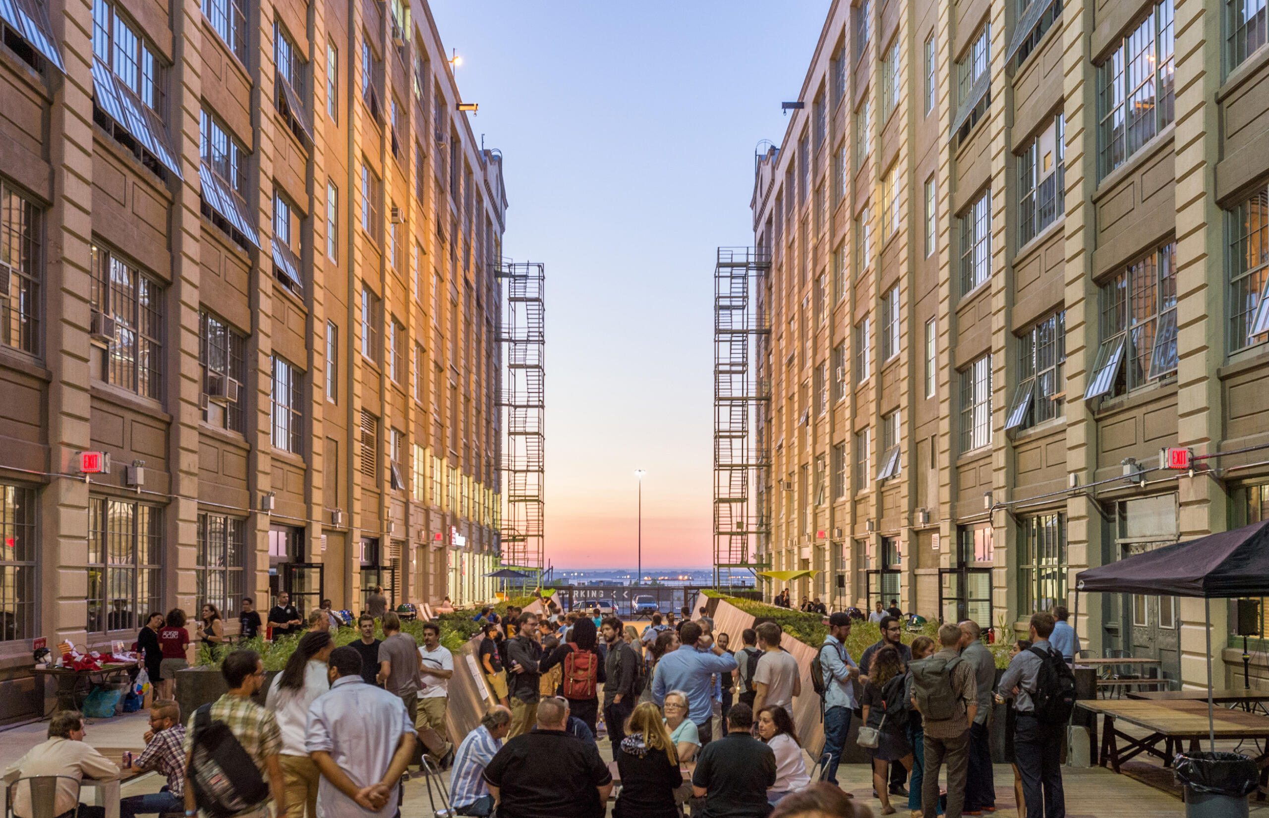 Industry City courtyard at dusk with attendees at an event
