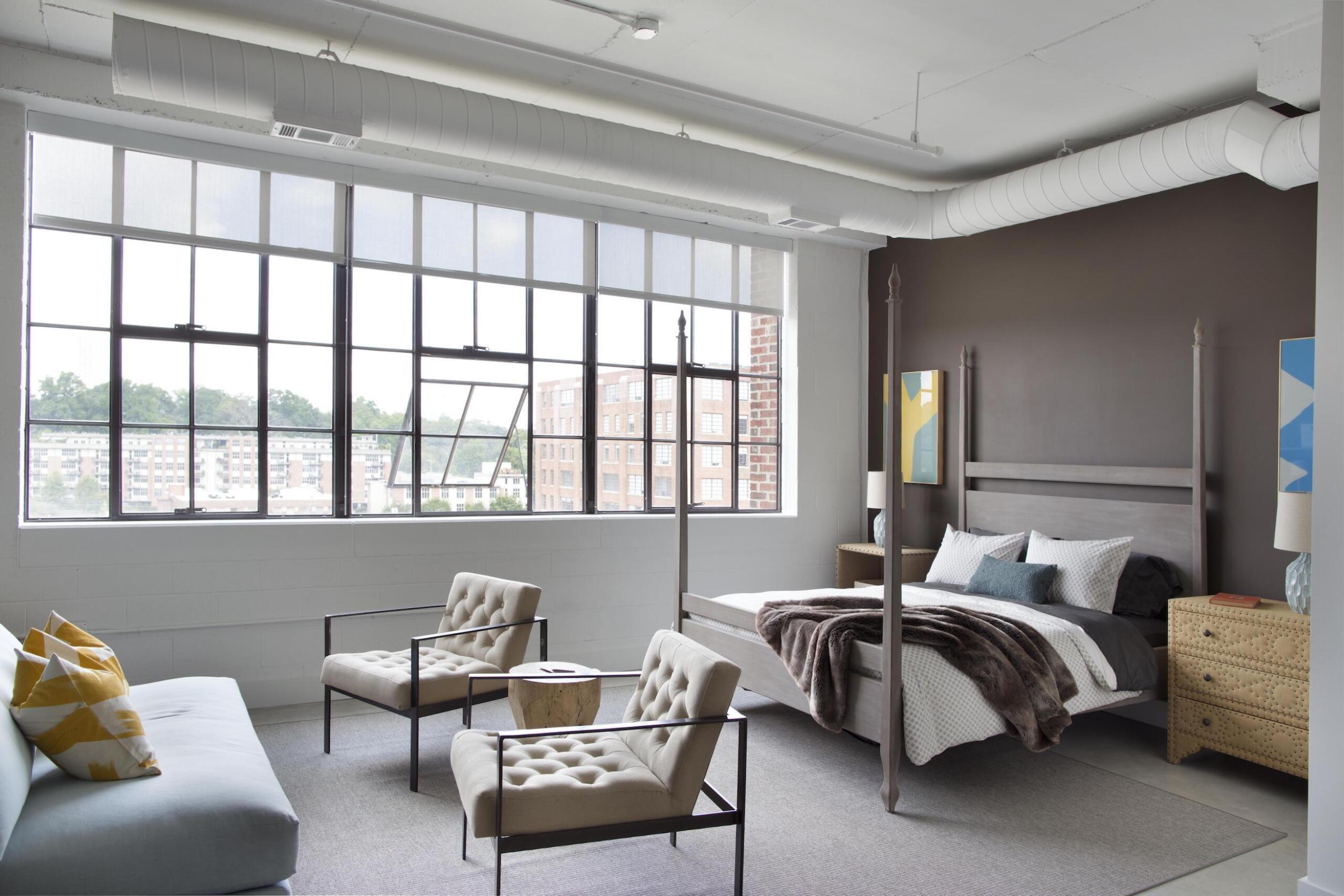 Flats at Ponce City Market bedroom interior with bed, sofa, and chairs