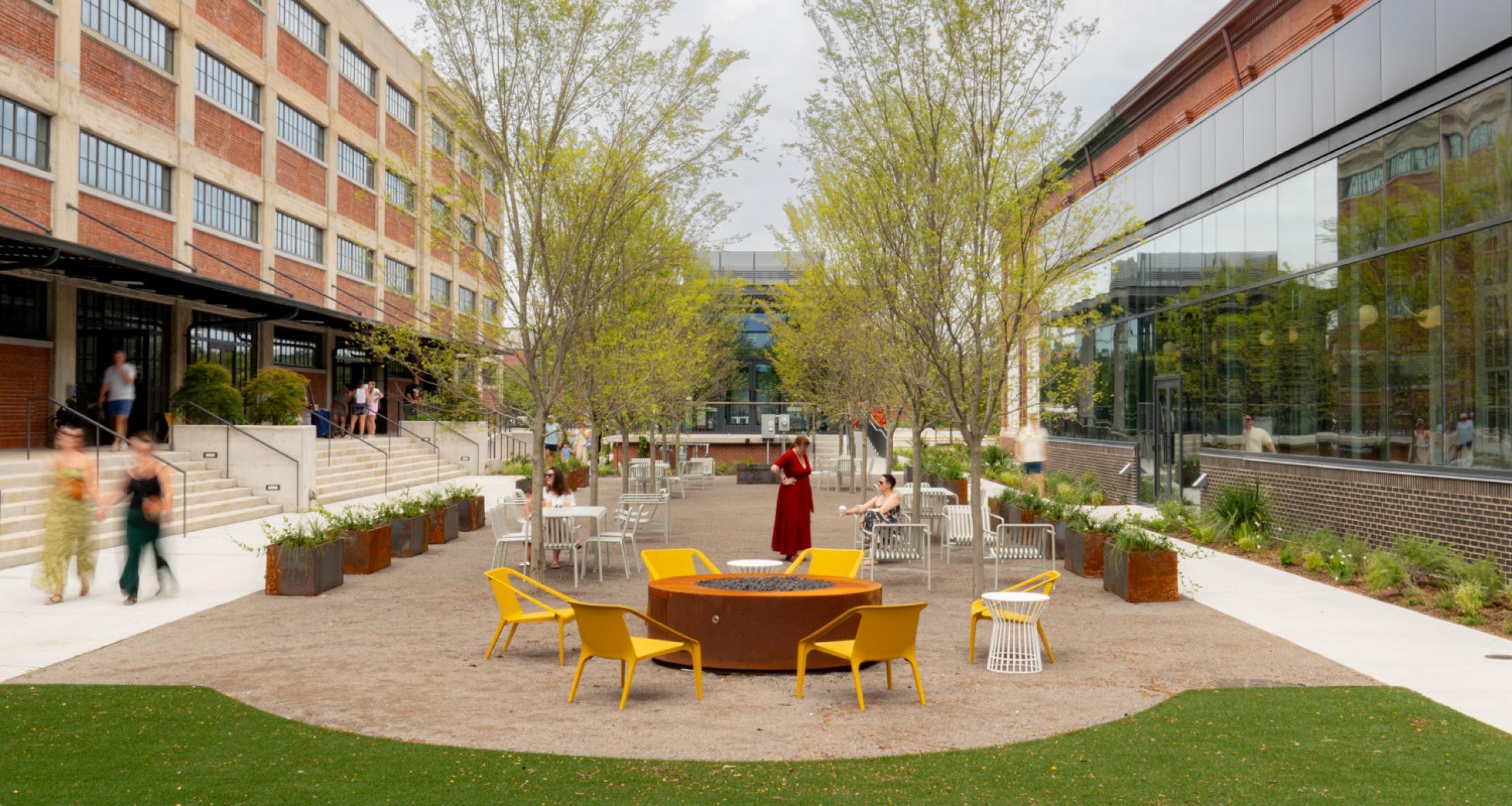 People gathered in a central outdoor courtyard at Navy Yard Charleston