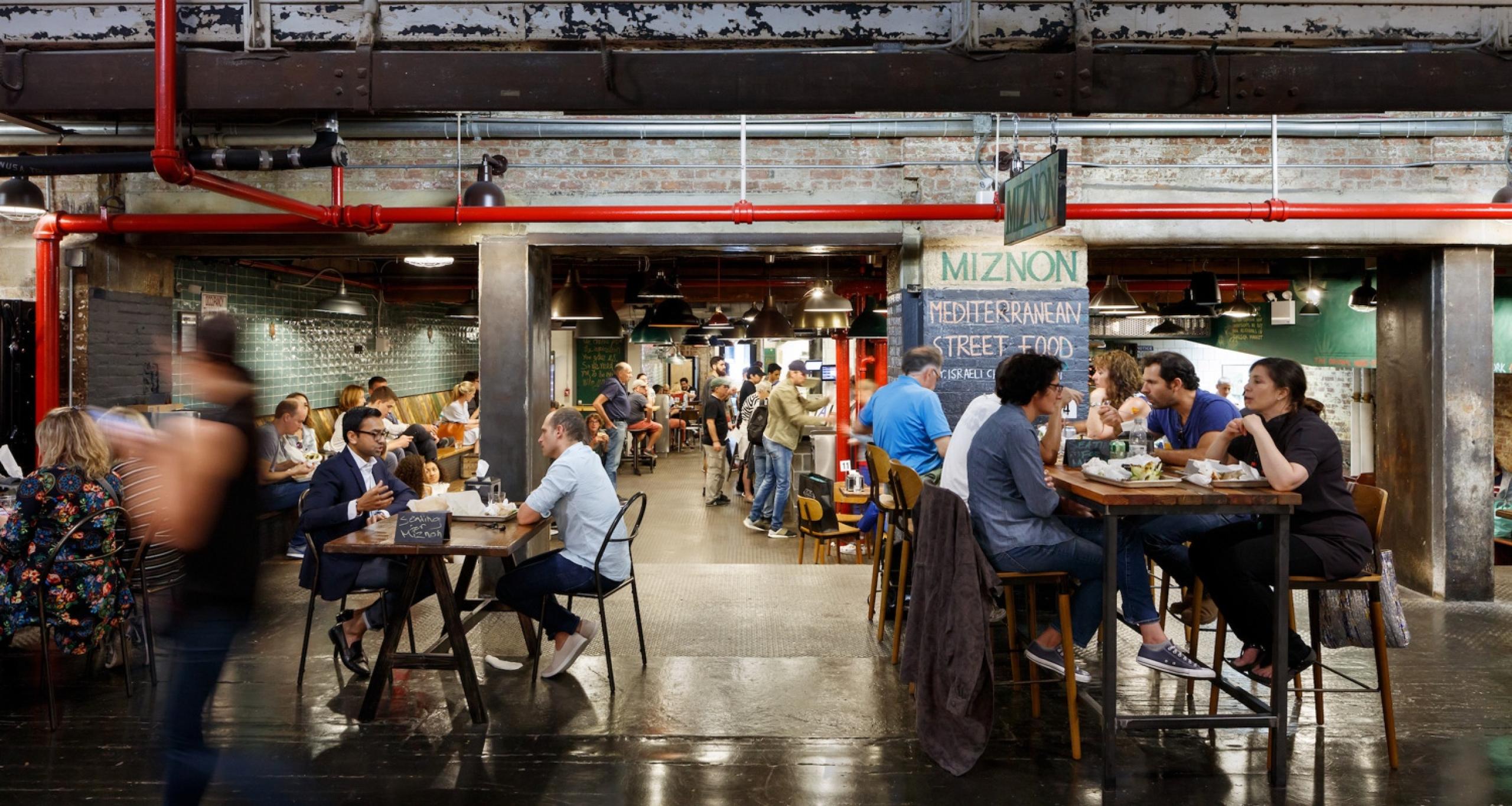 Visitors eating meals in a common area dining space at Chelsea Market