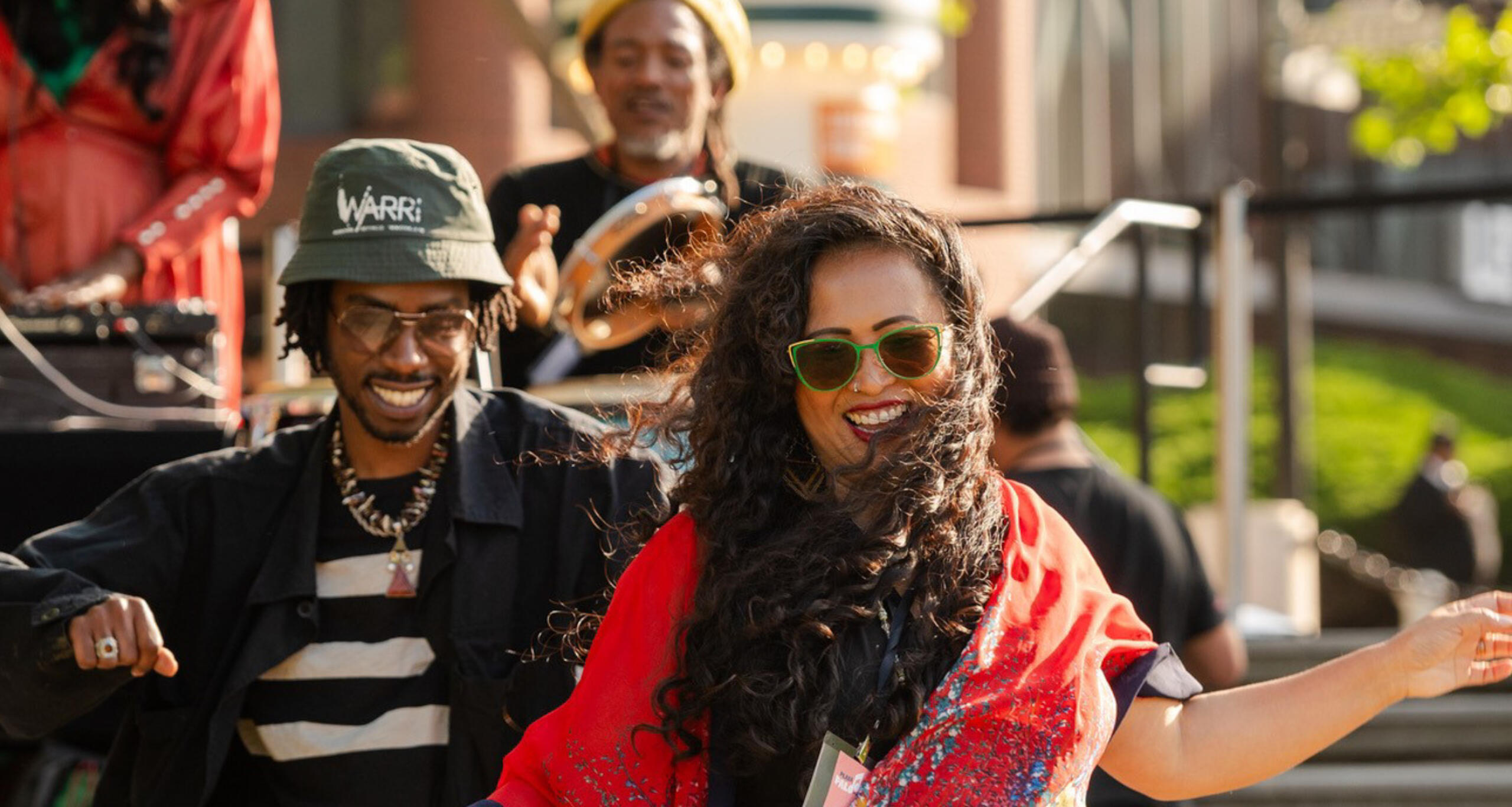 Concertgoers dancing in front of musicians performing live music