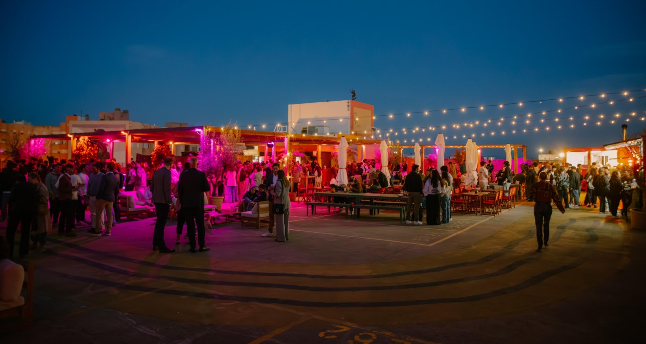 People at an evening event on the IDB Lisbon rooftop