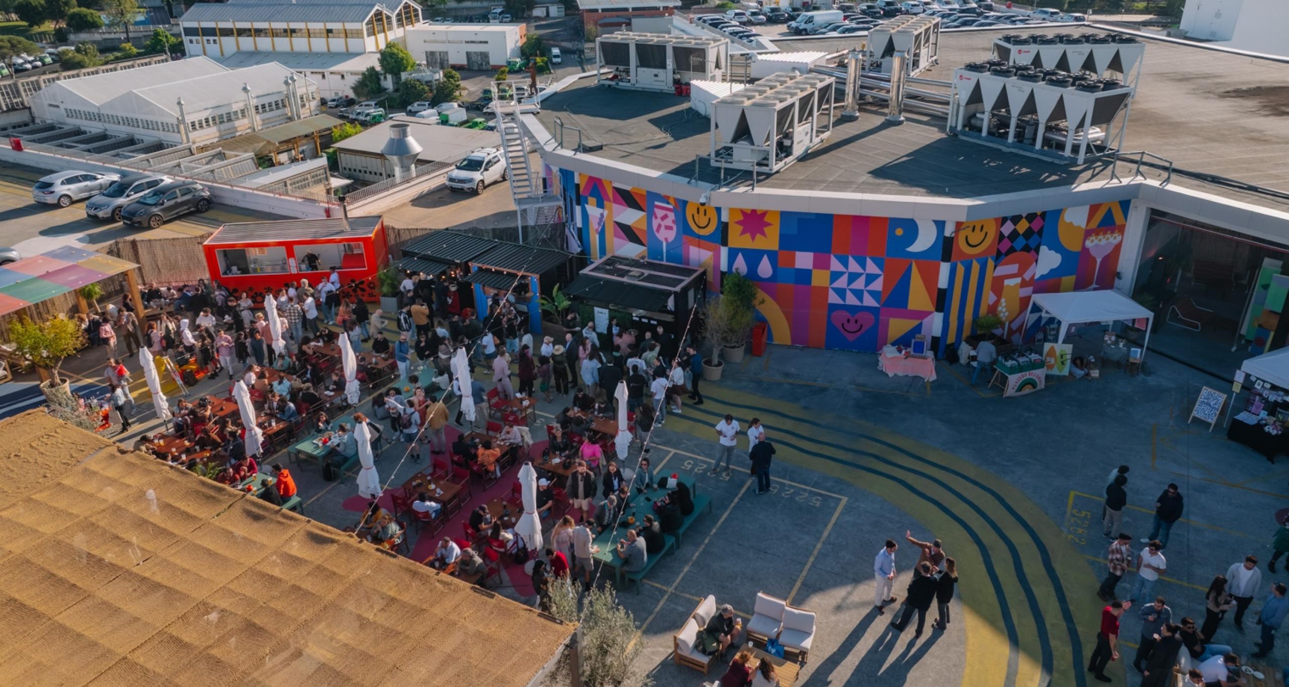 A crowd of attendees at an event on the IDB Lisbon rooftop