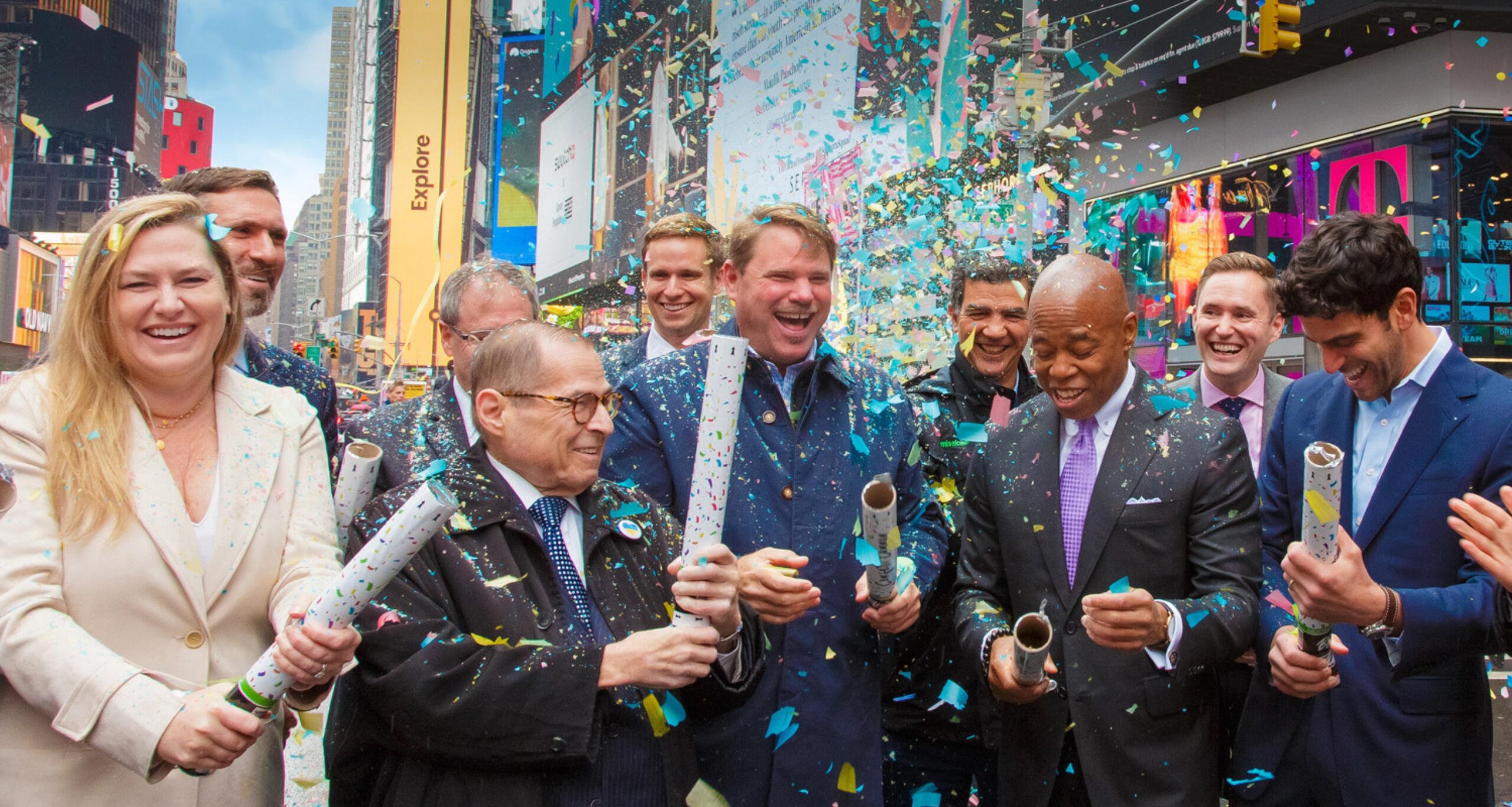 People gathered in Times Square launching confetti to celebrate the announcement of One Time Square's redevelopment