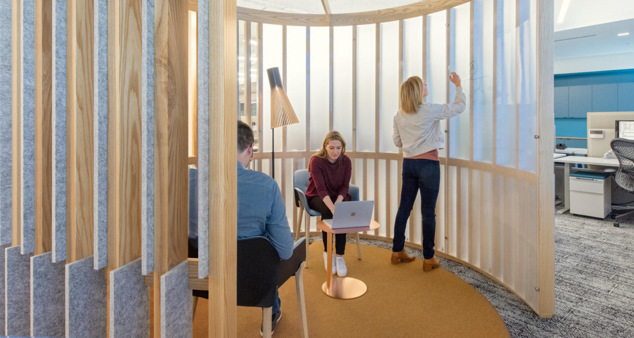 Three people working in an office at The Innovation and Design Building