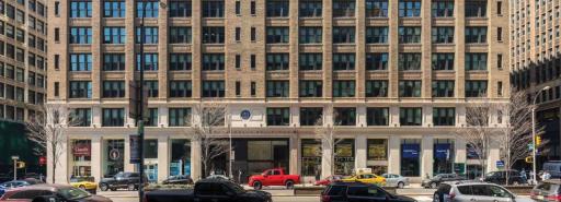 Exterior of 470 Park Avenue South's first 10 floors with cars on street in front