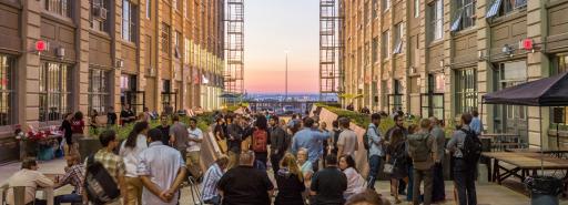 Industry City courtyard at dusk with attendees at an event
