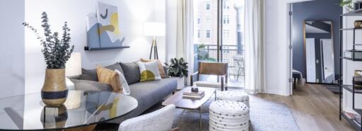 Living room of a model apartment at The Ellington with bright windows